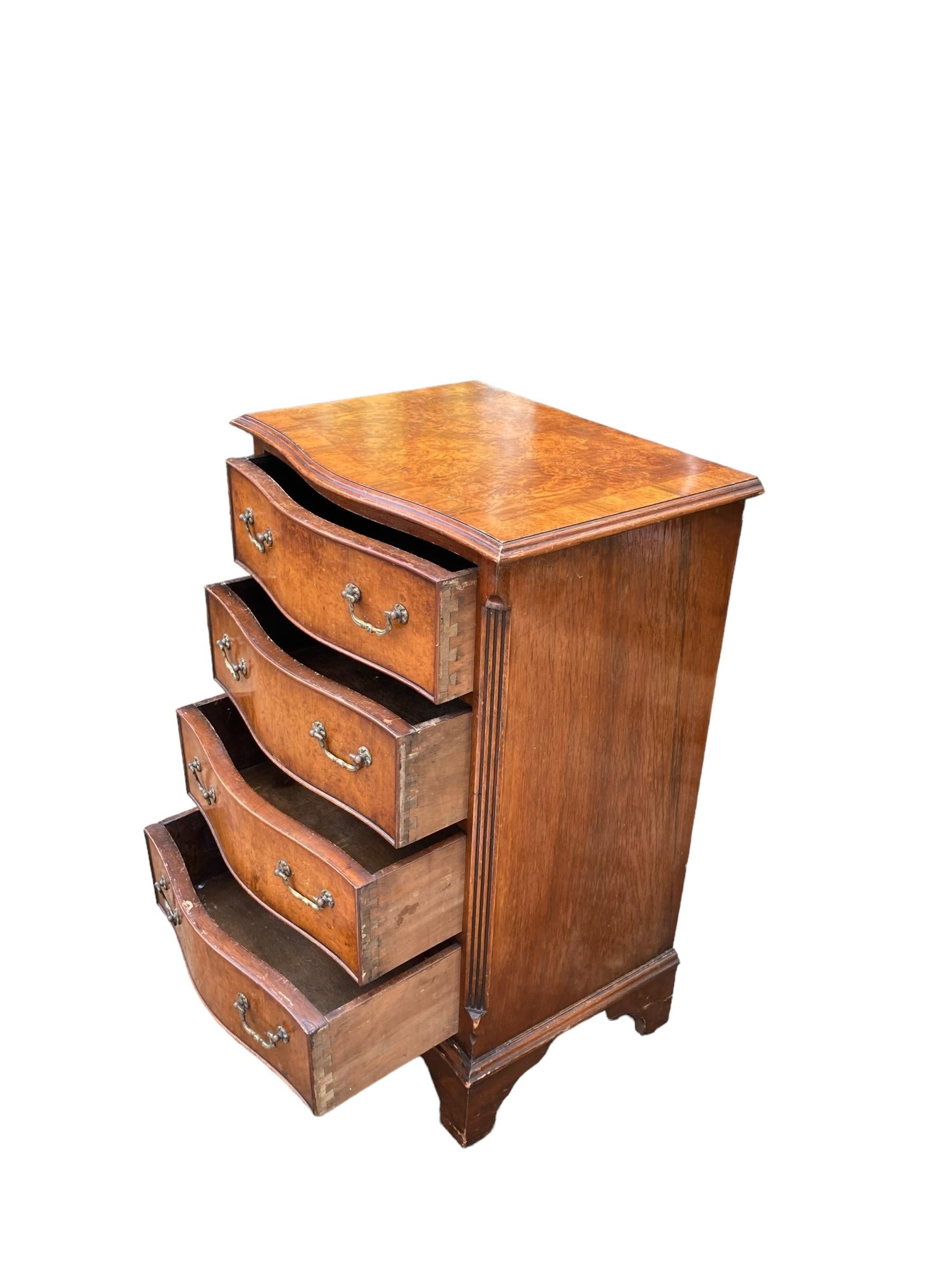 British Small serpentine burr walnut veneered chest of drawers. For Sale