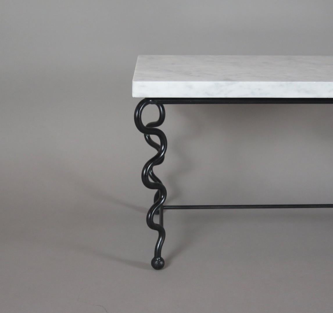 Contemporary hand-forged 'Serpentine' coffee table by Matthew Sidow.

Black wrought iron base with undulating legs and Carrara Marble Top. Each piece is handmade by our skilled artisans in the United States.

Please inquire for customization