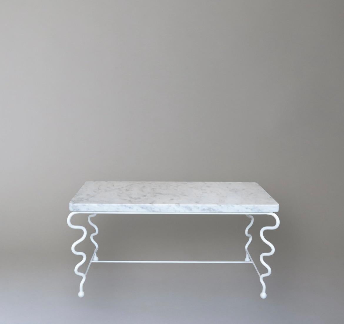 Contemporary hand-forged 'Serpentine' coffee table by Matthew Sidow. White Satin Finish.

White painted steel base with undulating legs and Carrara marble top. Each piece is handmade by our skilled artisans in the United States.