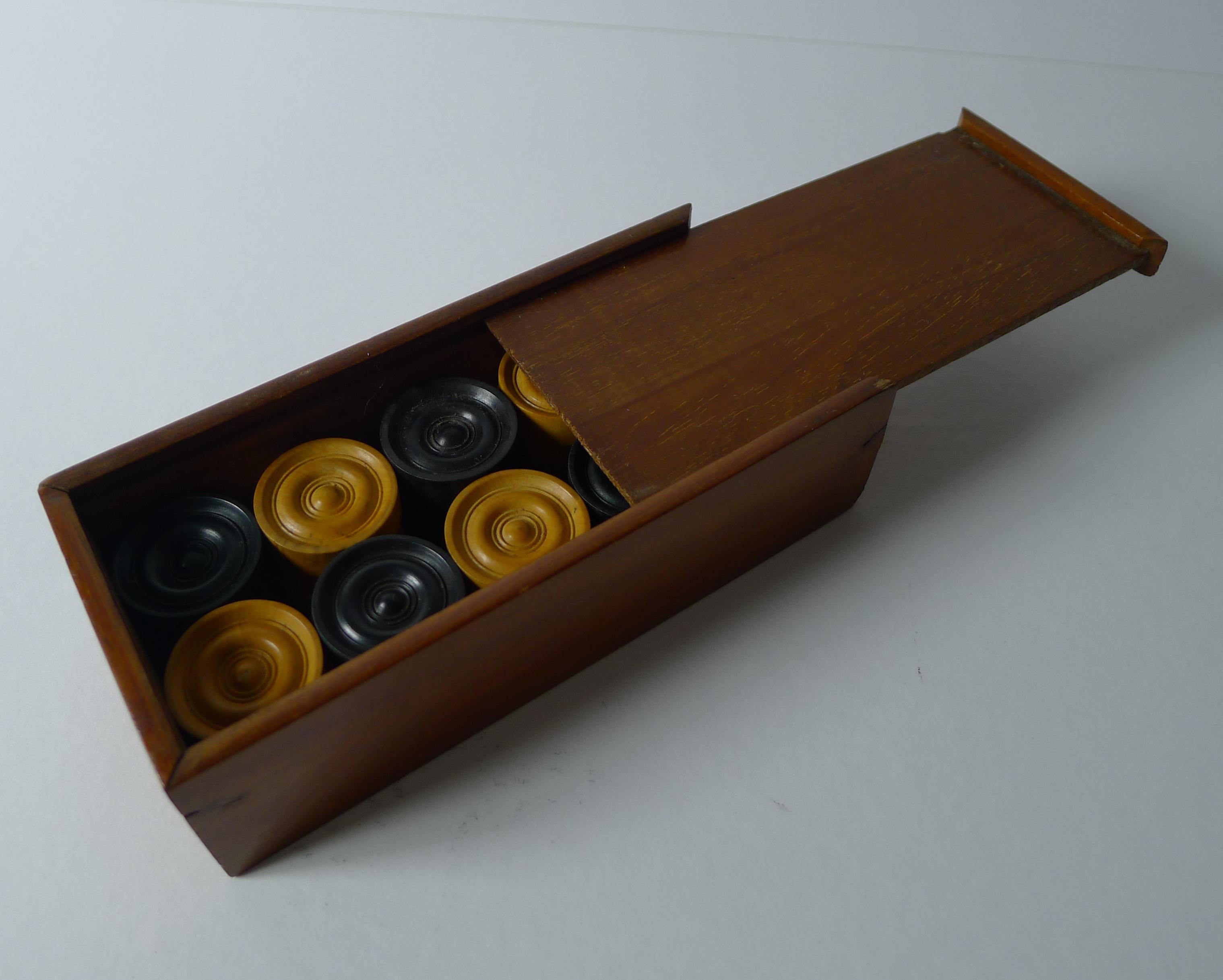 A beautiful boxed set of gaming counters, perfect for Draughts / Checkers / Backgammon / Triktrac.

The counters are made from turned wood, all in very good condition each measuring 1