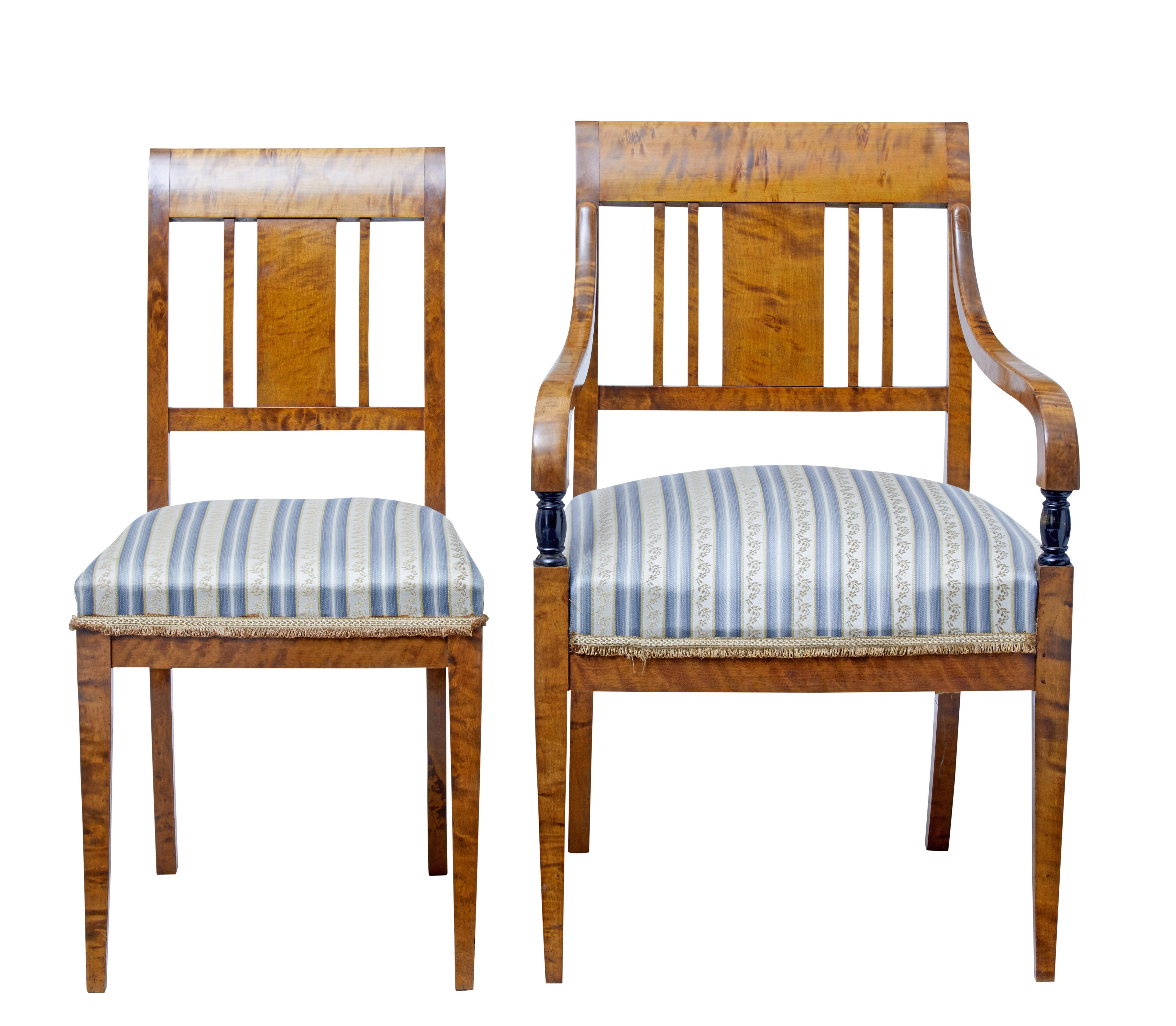 Good quality set of two arm and two single dining chairs, circa 1910.

Ideal for the home or office where a large set is not needed.

Burr birch with elegant backrest design. Shaped arm on the carvers which leads down to an ebonized