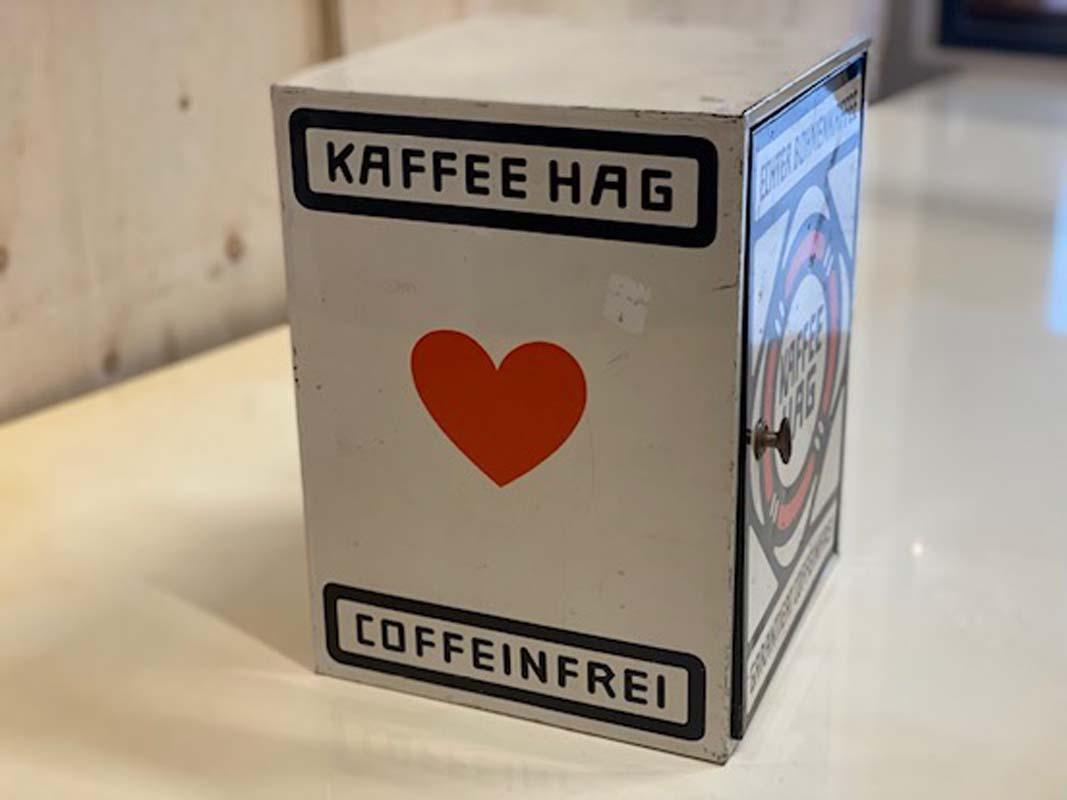 Vintage tin cabinet from Kaffee Hag from the 1st half of the 20th century. The little tin box was originally intended for presentation of goods in the store. The 4 sides are designed differently. On 2 sides is the logo with lifeline, on the other 2
