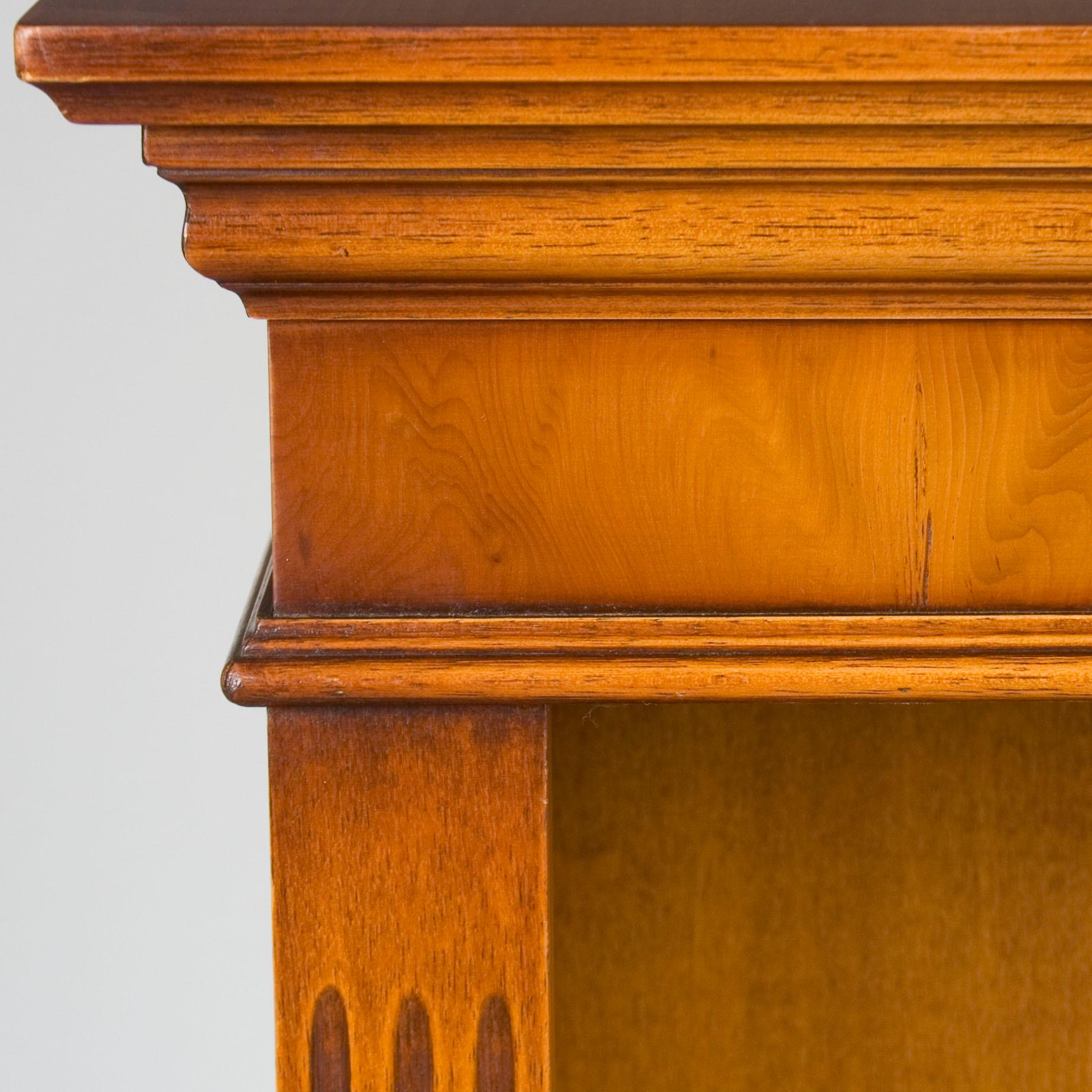 Simple but elegant, this short antique bookcase exhibits a stylish and charming way to display books. Yew wood provides an elegant appeal while sturdy shelves provide lots of room. Whether in the office or the living room, this bookcase blends well