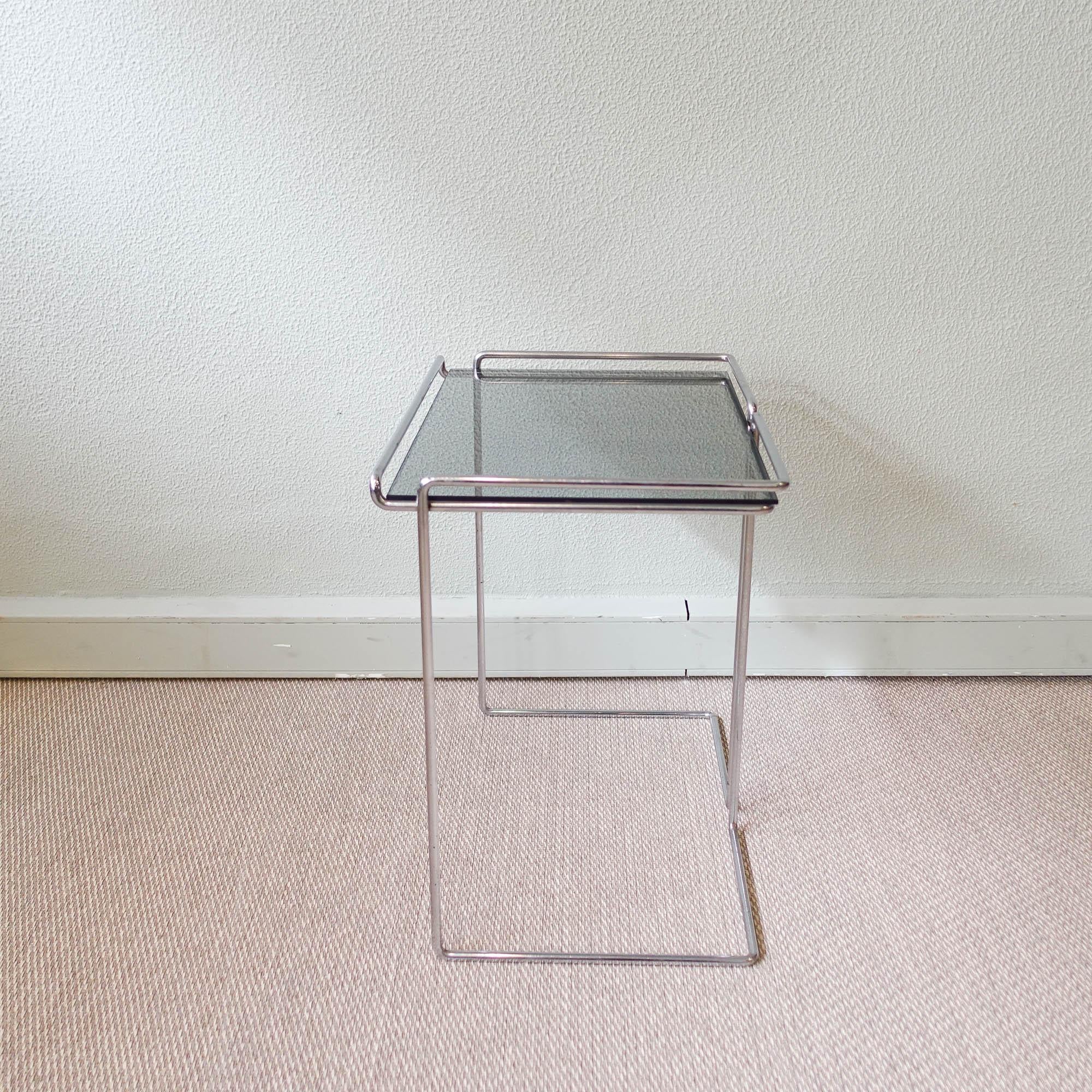 This side table was designed and produced in France, during the 1970's. Graphic, minimalist design, made of chromed wire steel and a smoked glass top. Similar to the Isocele design, from Max Sauze for Atrow. In original and good vintage condition.