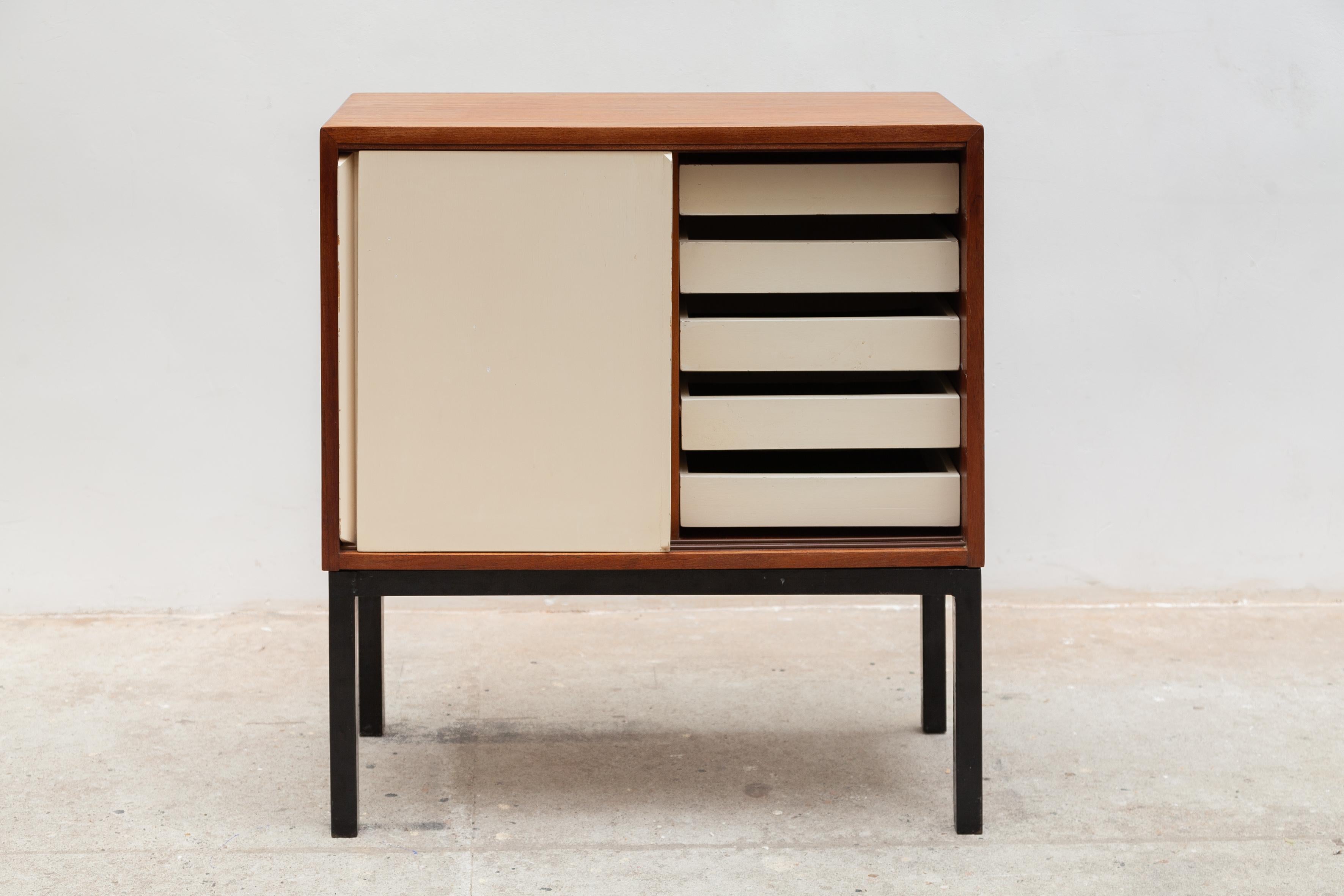 Small sideboard with a special French fifties basic industrial character. Featured metal framed base black lacquered with on top a volume cabinet sideboard in wood and lacquered white doors and a handle in wood. Interior two compartments with one