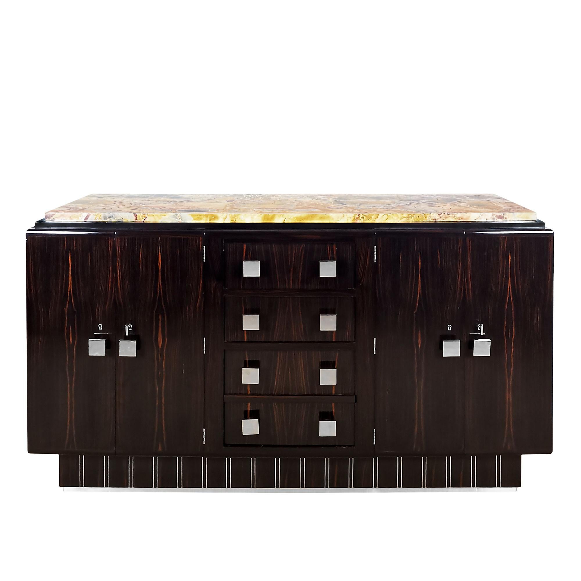 Small 4 doors and 4 drawers sideboard in solid wood veneered with Macassar ebony. Ebony and polished aluminum base, doors opening onto a mahogany interior (height-adjustable shelves), multicoloured marble top.
Handles, keys and hardware in
