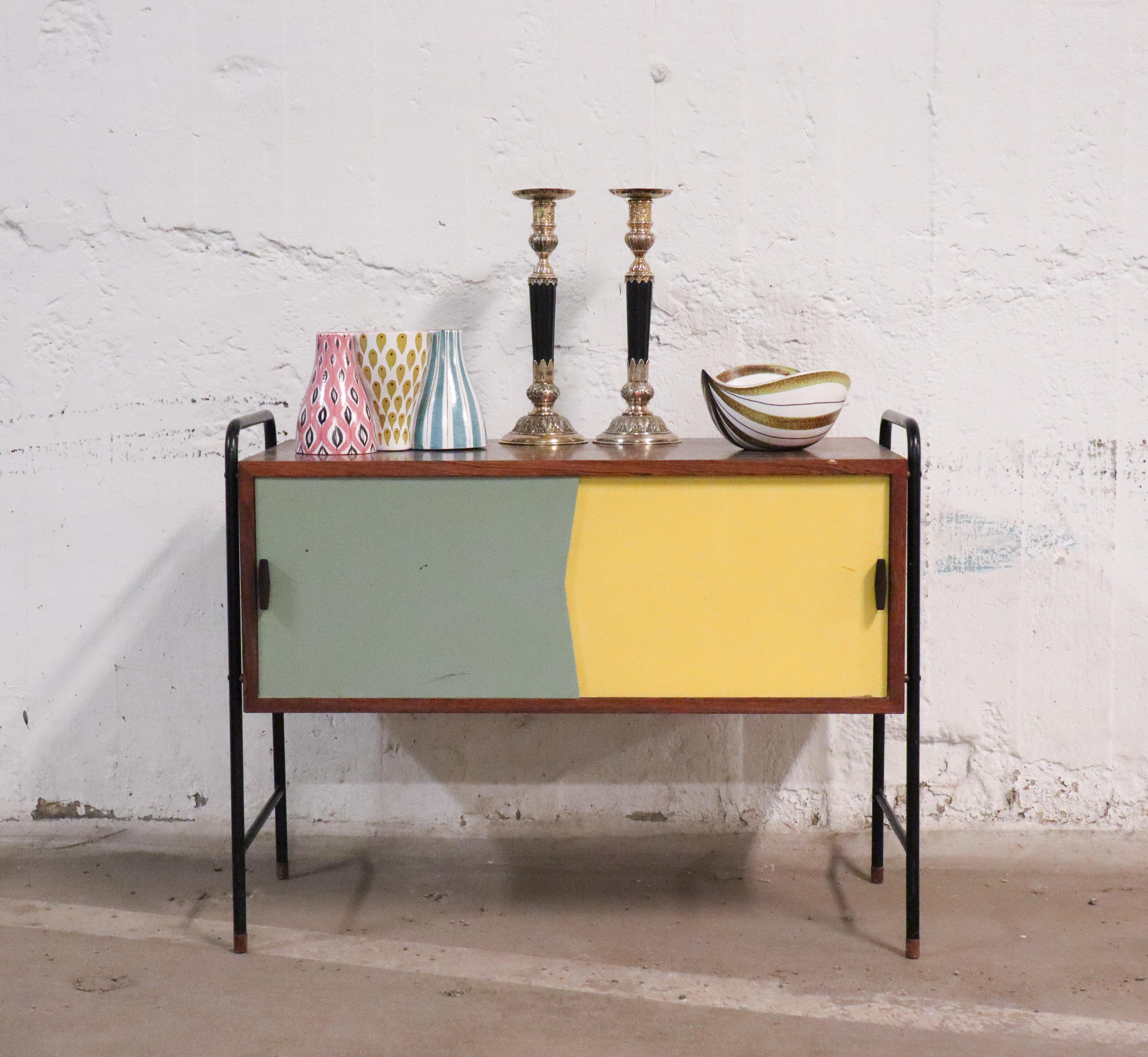 A lovely small side board from the 1950s probably designed in Denmark by unknown maker. The sideboard do have two sliding doors in yellow and gray. It is 54 cm high and is in very good condition except from a small mark at the edge and some minor