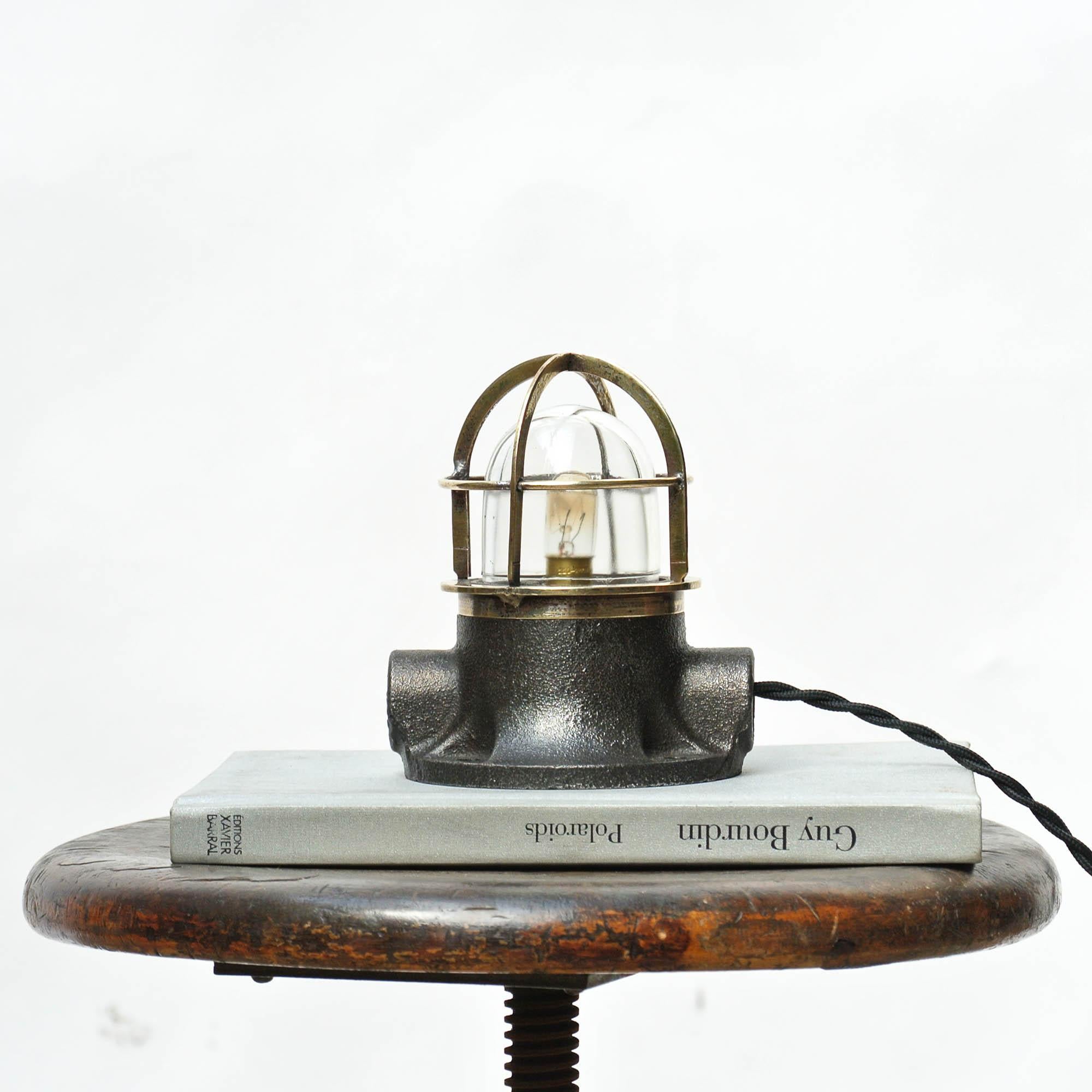 Pretty small vintage signal lamp. Base in cast iron, patinated and polished. Thin fence in brass protecting the glass part. Use it as a desk lamp (or a sconce / wall light, ask for this option), circa 1960.

 