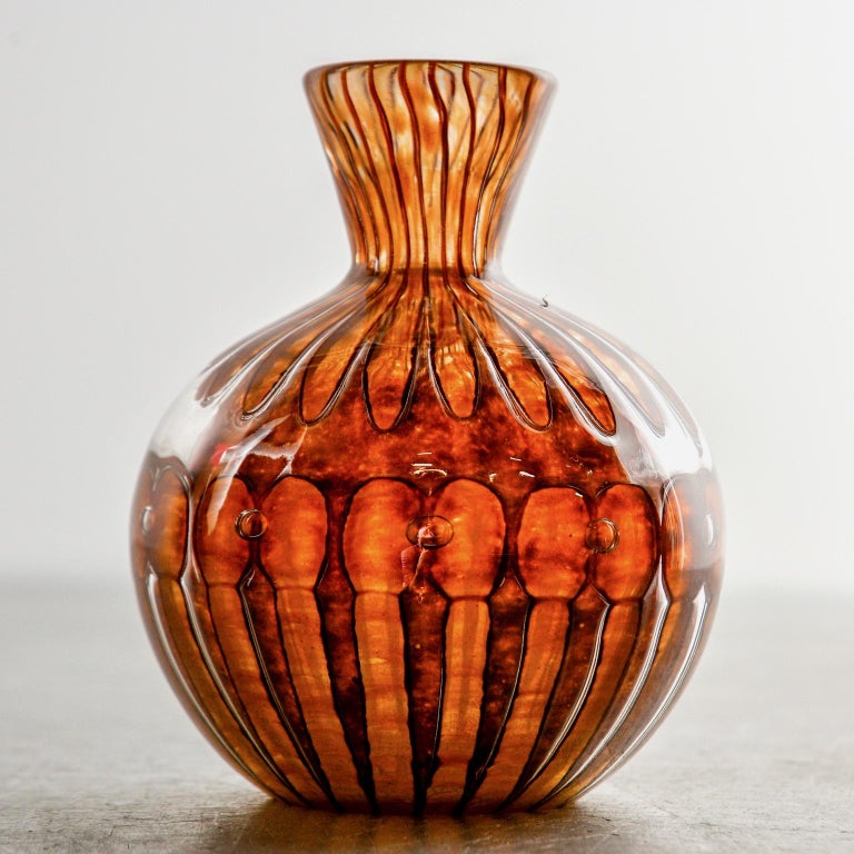 Vase by Verlys in a mottled amber art glass that resembles tortoiseshell, circa 1940. Round shaped body and narrow neck. Etched signature on underside of base.

 