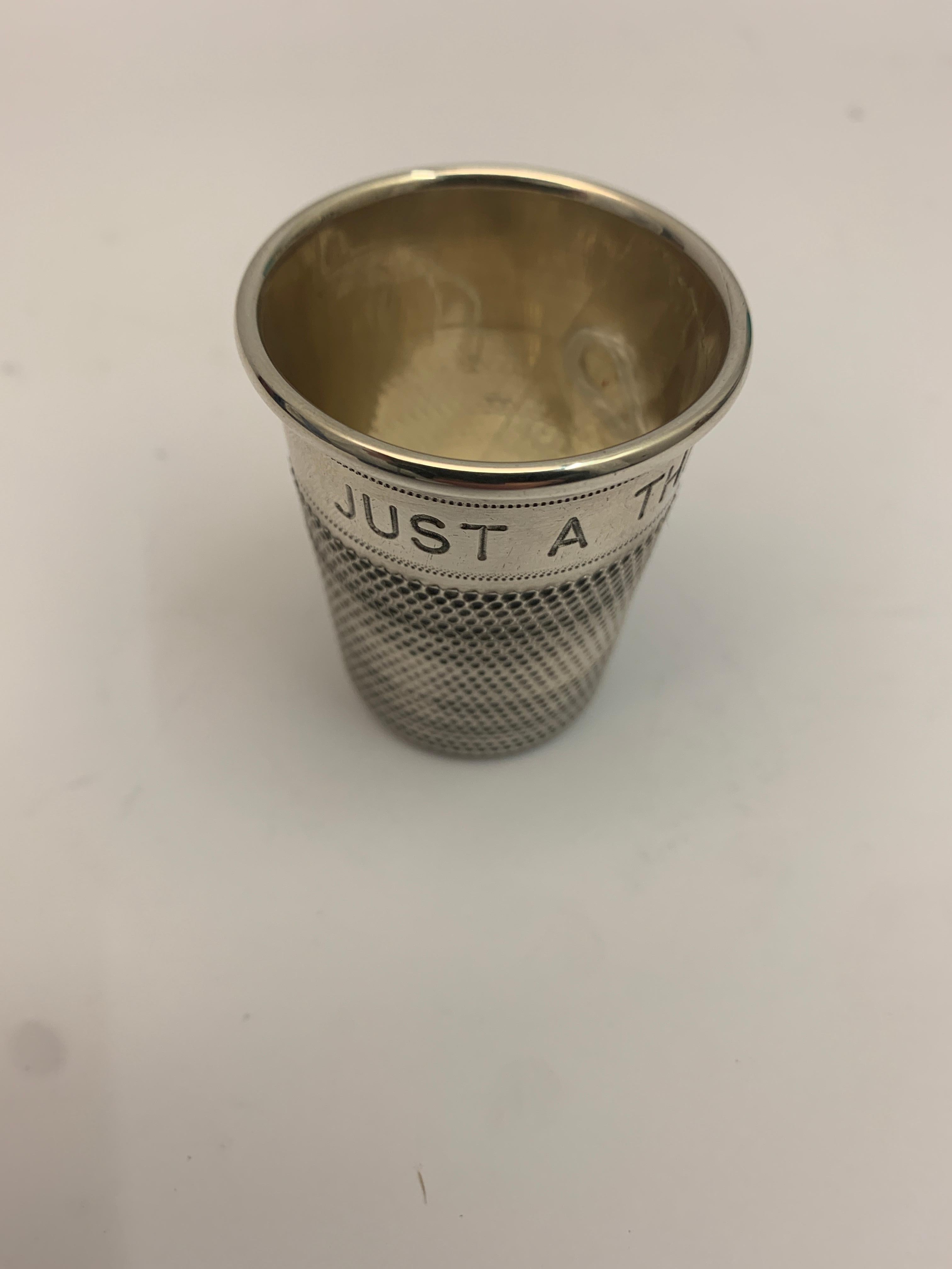 A small patterned 1.5 oz silver thimble. Inscribed with 'Just a thimbleful' fully hallmarked, 1978.
