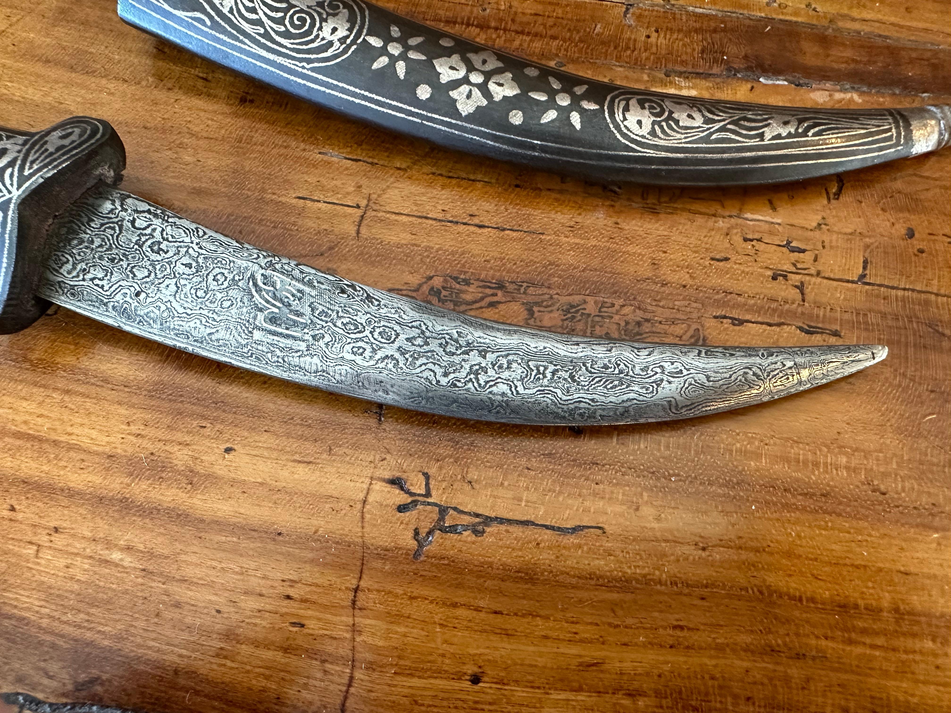 Small Silver “Jambiya” or Curved Dagger With Its Sheath. These are often Extremely well Crafted with Extraordinary inlaid Silver Designs accentuated with “Neillo”.  This Inlaid Handle is unusual fine. These  were worn to Emphasize a Man’s Status.