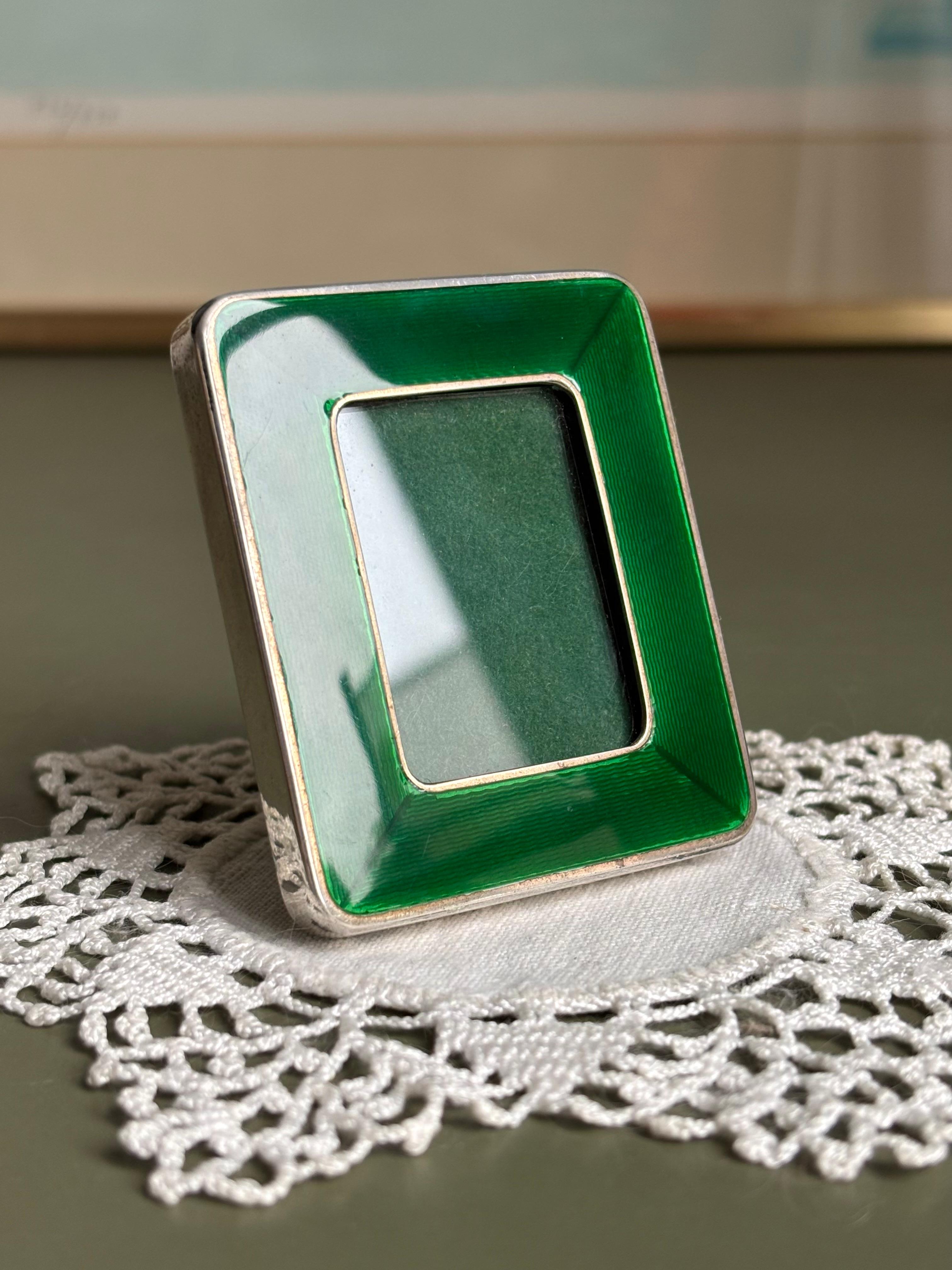 Pretty little silver picture frame with emerald green enamel front and olive velvet back and green felt to protect the clear glass. 
In the style of Cartier and attributed to Italian designer Franco Salimbeni. 
Stamped on side. 
Beautiful vintage