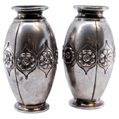 Small silver vases embossed with floral motifs