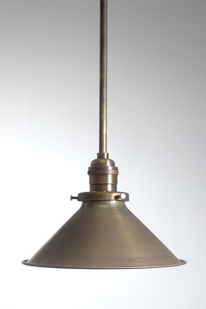 This is a nice simple spun brass shade it is heavy gauge with a rolled edge. The outside hde a dark brass finish and the inside is lightly silvered. There is 7.75 inch diameter and the height is 5.75 inches plus the pipe drop length you require.