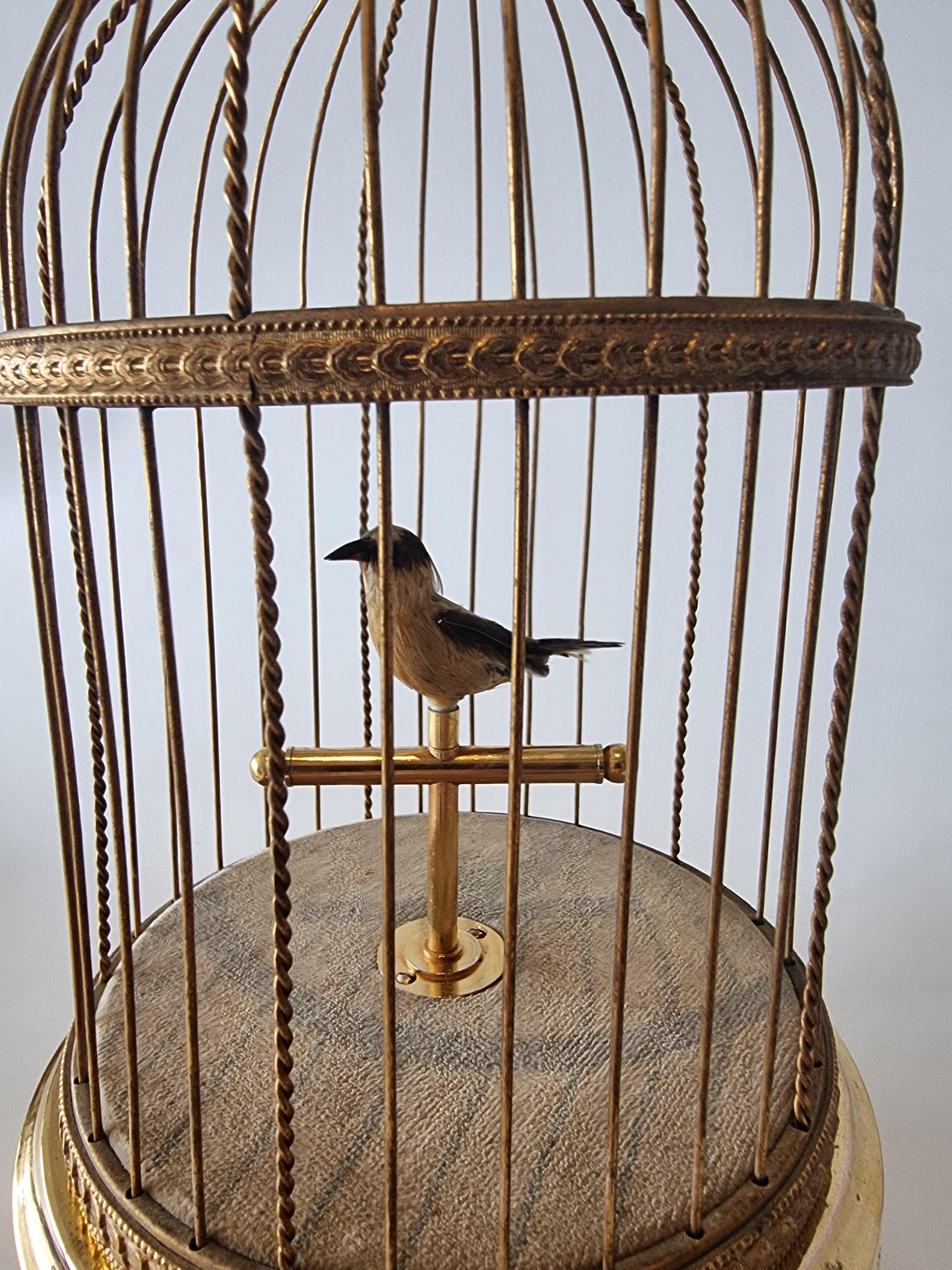 A small size singing bird cage by Reuge of Switzerland, with intermittent and continuous action settings. When wound and the start/stop lever slid to full position, the perched bird sings the jolly and melodic continuous phases, perfectly