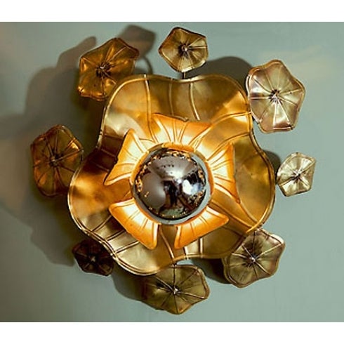 These ultra glamorous lotus flower wall lights provide perfect mood lighting either singly, as a cluster, or as an entire wall installation. Made in solid brass and soldered with silver these organic sculptures appear to grow out of the wall. Each