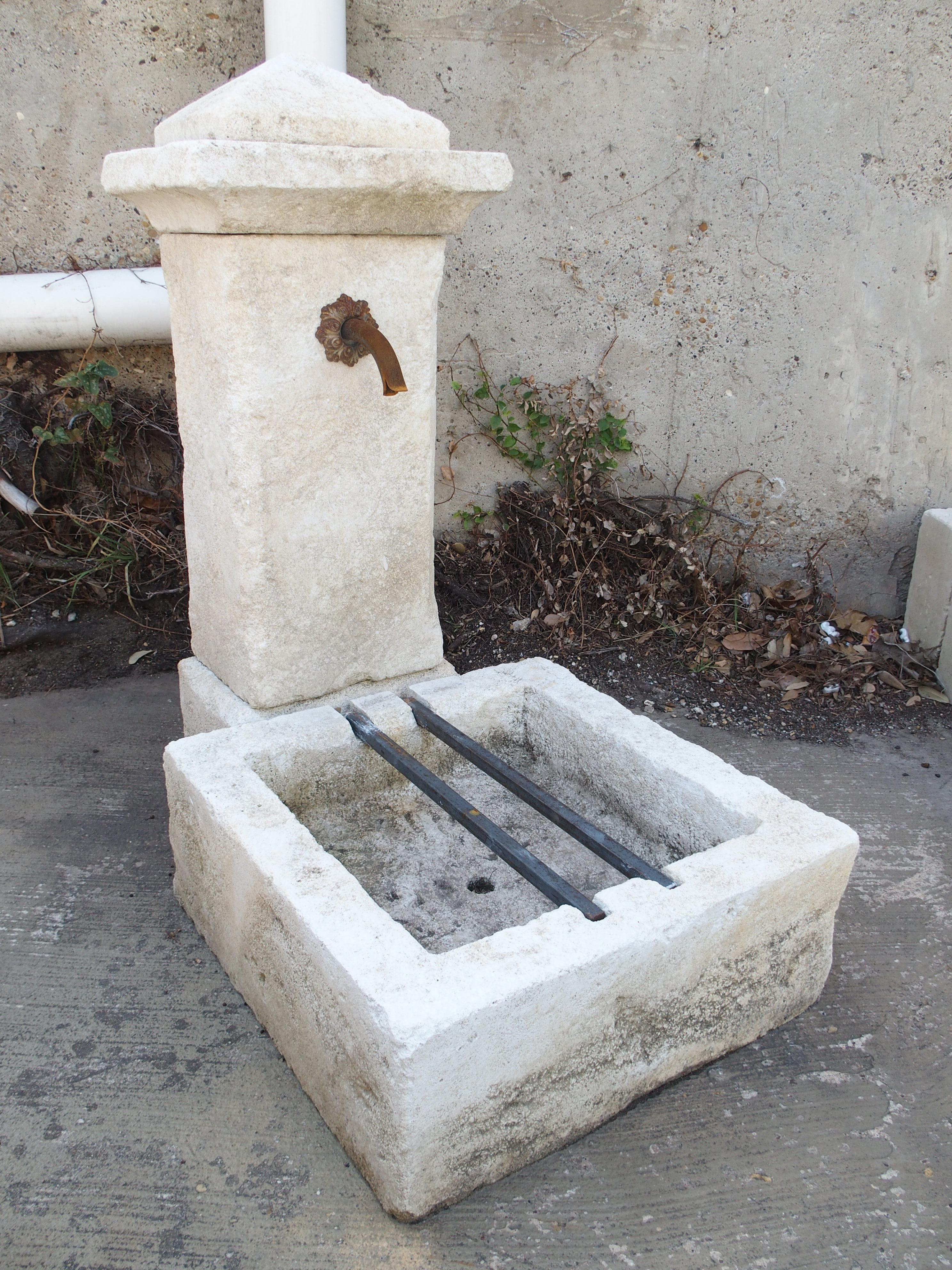 Consisting of five pieces of Estaillade limestone, this small single-pillar fountain was hand-carved by a stone mason in Provence, France. The freestanding fountain is quite versatile, as it could be positioned as a wall fountain or used as a