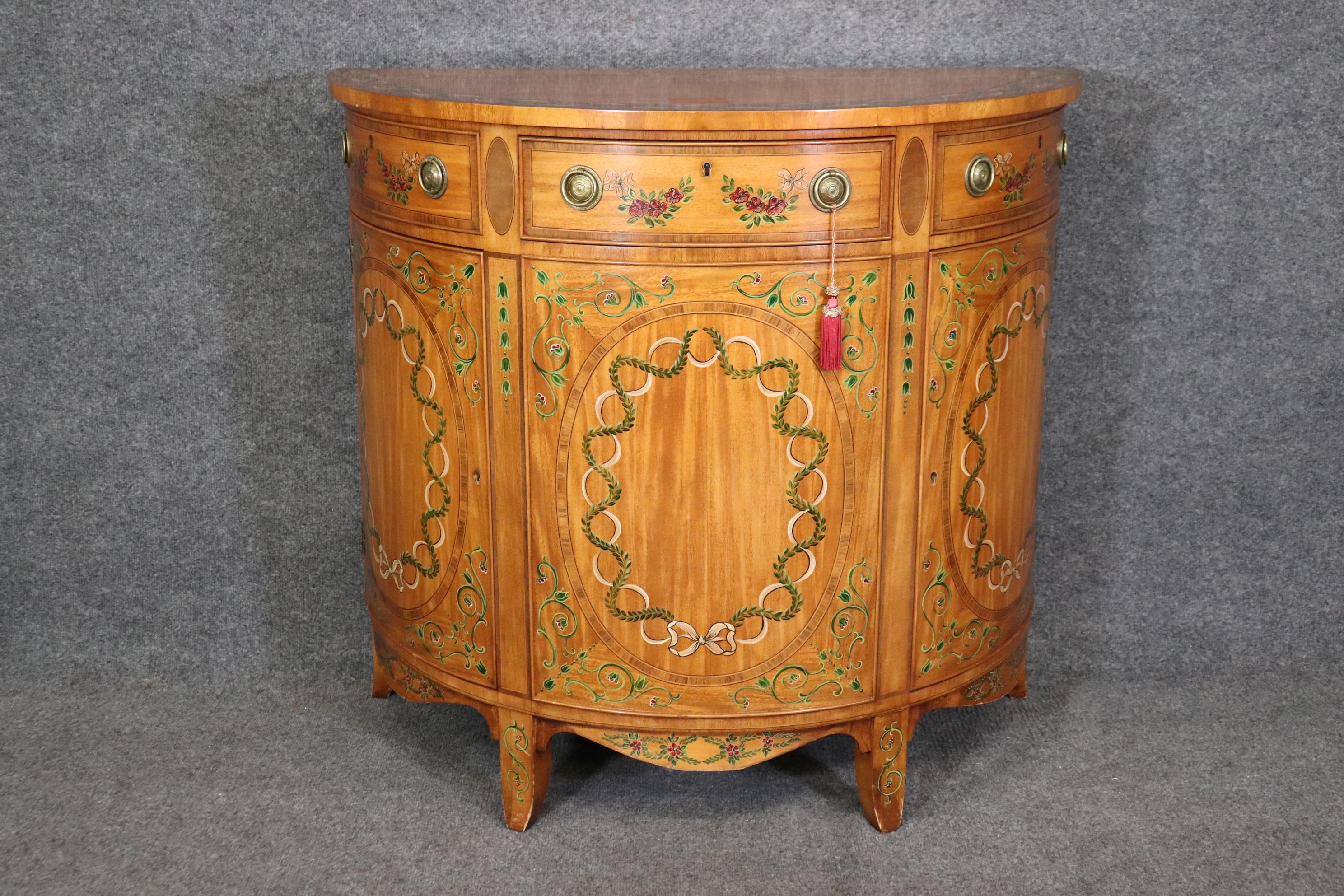 This is a charming Wellington Hall Adams style paint Decorated commode or nightstand. The stand is in good condition with minor signs of use and wear as its not old. The commode meaures 34.75 tall x 38 wide x 19.5 tall and dates to teh 2000-2010
