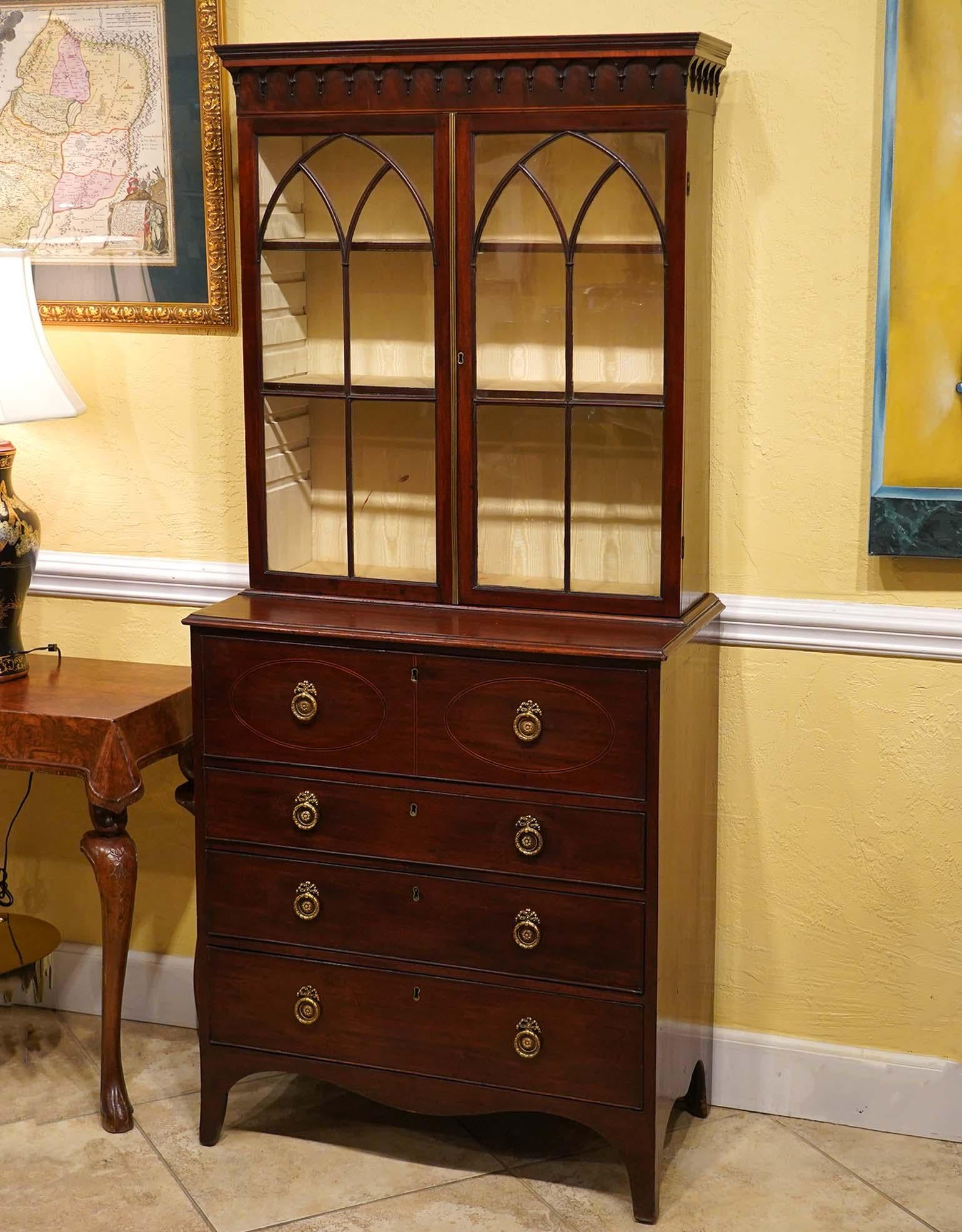 Of a very attractive small size this Georgian inlaid Mahogany Bookcase Secretary Desk dates to circa 1820 and features a bookcase with adjustable shelves and lined with moire silk. The upper drawer of the secretary desk can be pulled out revealing a