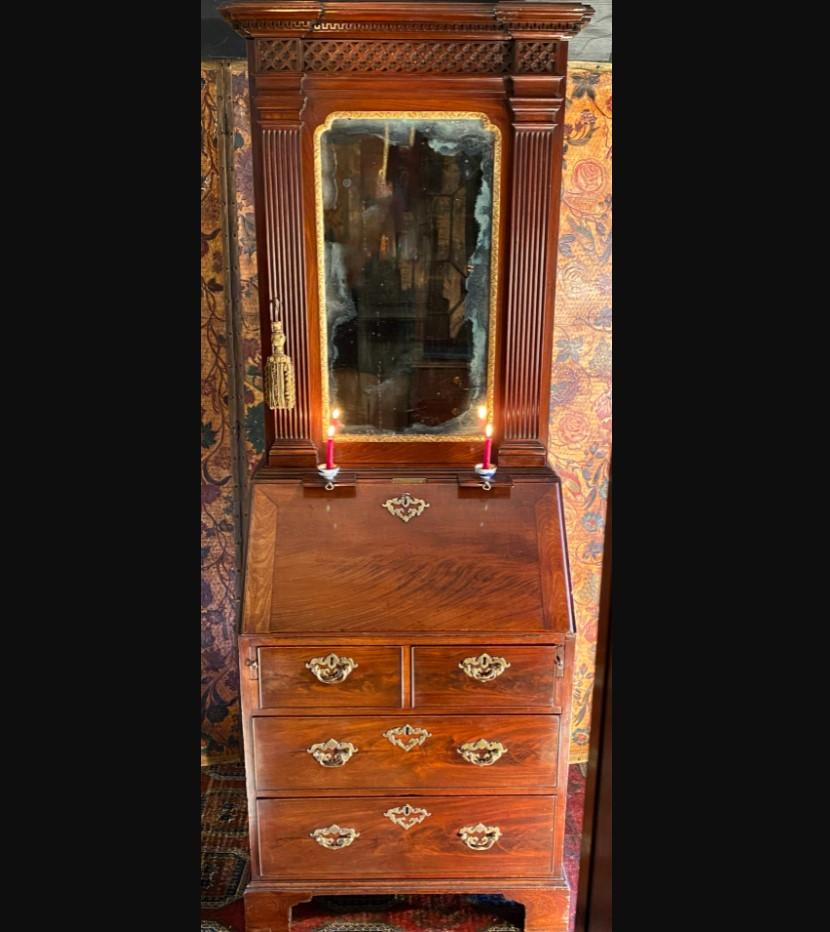 A small mid-18th century mahogany bureau bookcase or cabinet. 
George II period, circa 1740.

This diminutive Georgian bureau bookcase (also sometimes referred to as a ladies cabinet) is of rare architectural form, with boldly-fluted pilasters