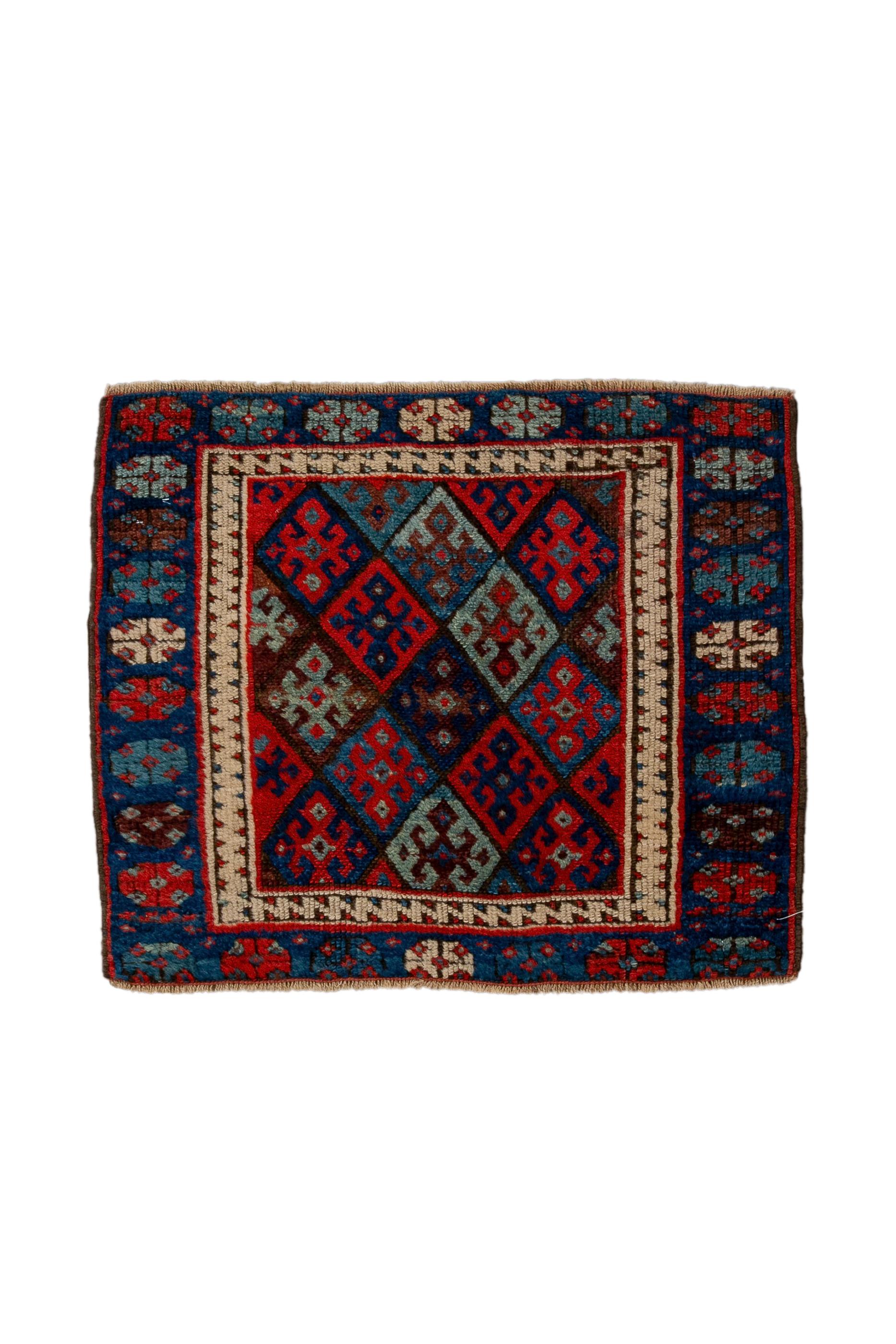 The Sewan Kazak design of a spear- headed and winged pale green medallion on a light red field, as here, is the classic Kars Kazak design. Stylised trees in each field corner.  Straw-ecru border with calyxes and slanted, serrated leaves. Kars, along