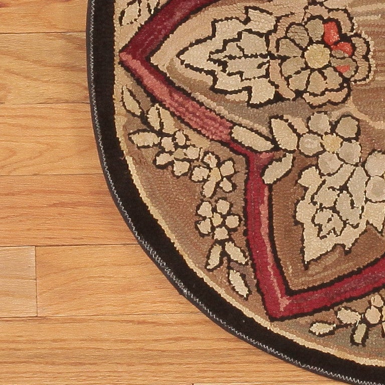 Beautiful small antique floral round American Hooked rug, country of origin: America, date circa 1900. Size: 2 ft 8 in x 2 ft 8 in (0.81 m x 0.81 m)

This antique rug was made in America circa the year 1900. One of the most striking thing about