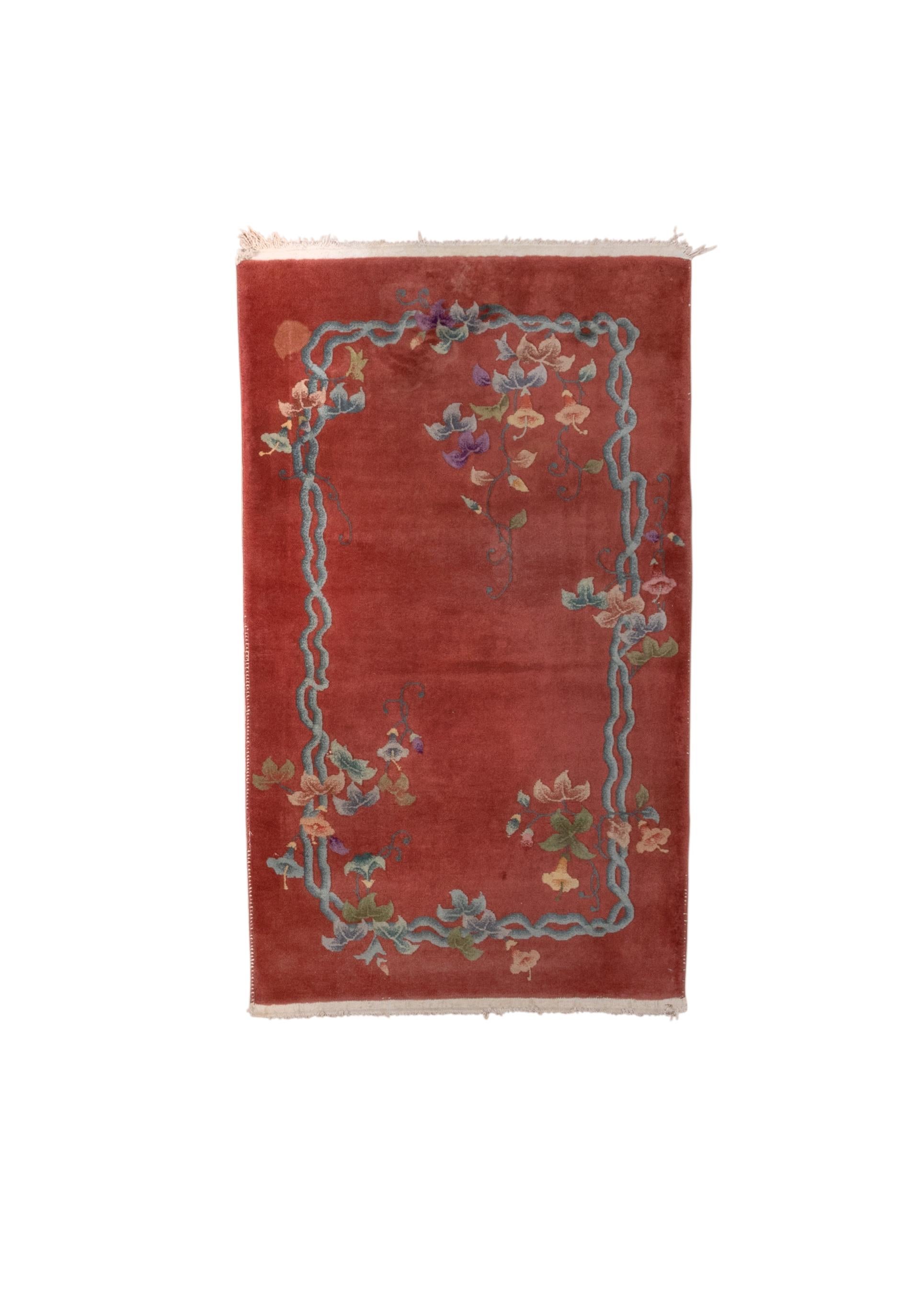 This well-preserve scatter shows a full terra cotta field with a twisting, double light blue tendril on all four sides, asymmetrically set with morning glory flower sprays in two opposite corners.  Shading of floral elements. Thick and heavy weave.