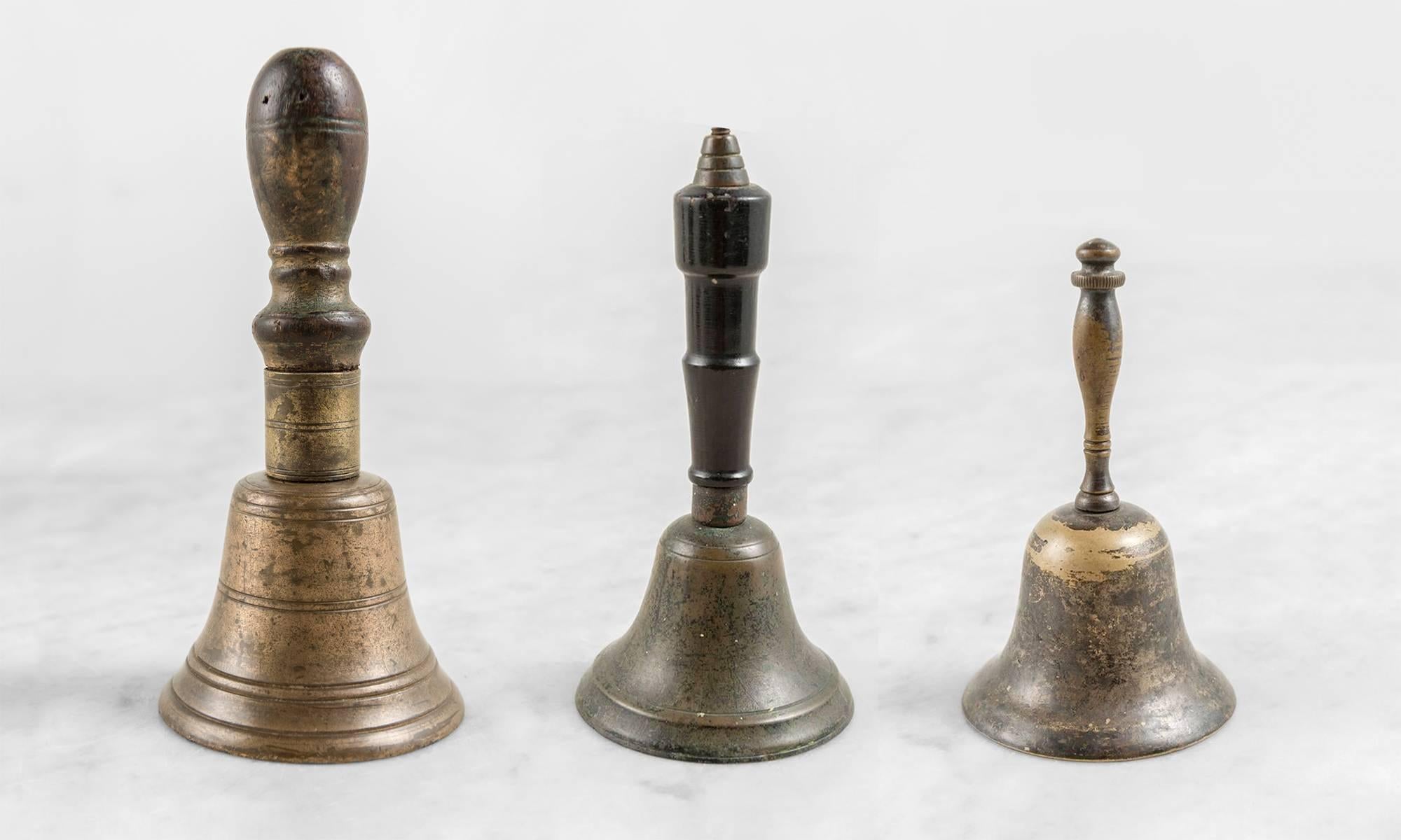 Assortment of hand bells with turned and ebonized handles.

Made in America, circa 1900-1940.