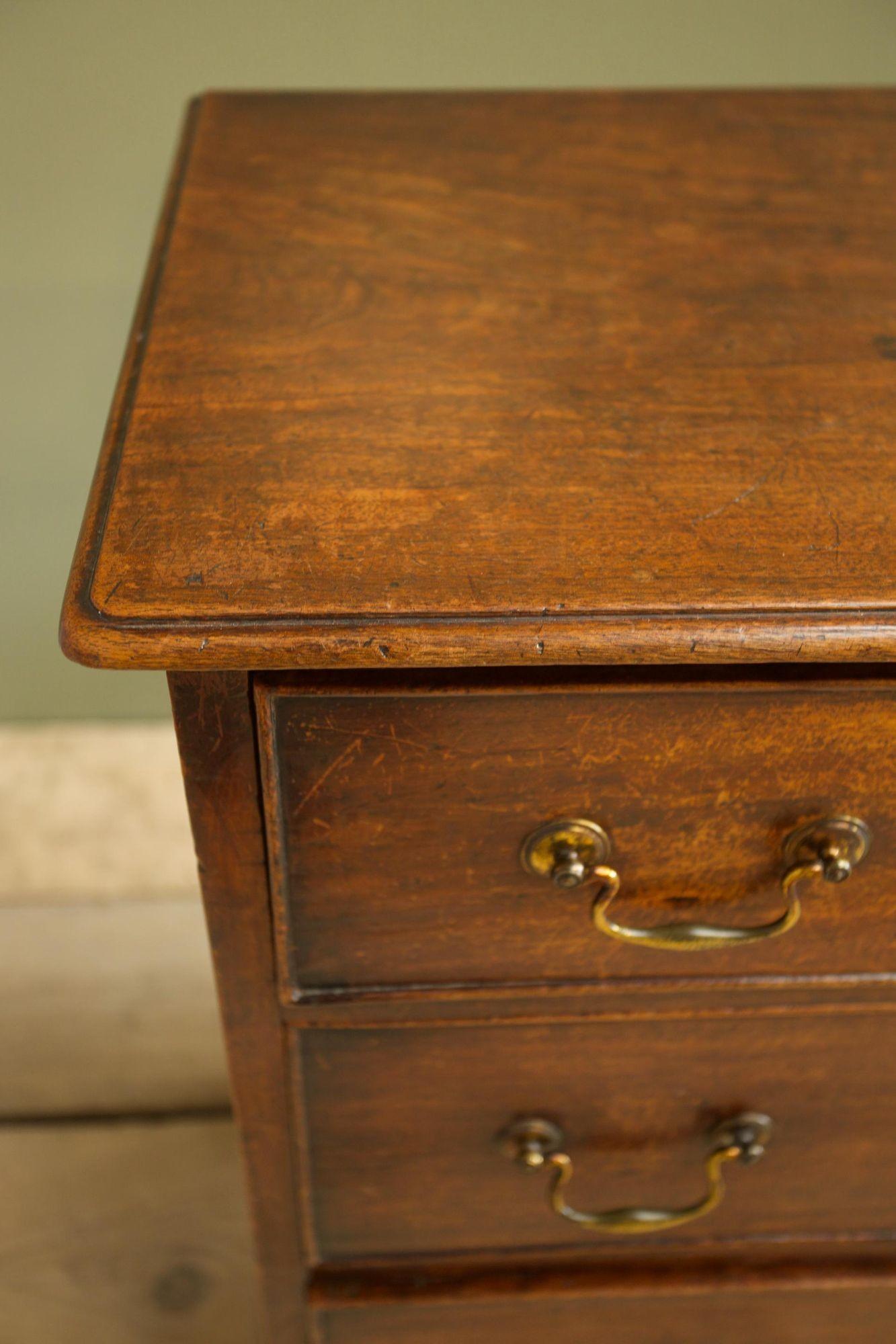 This is a very sweet Georgian mahogany chest of drawers. Smaller than average proportions and in nice original condition. The wear on the piece is very attractive and gives the piece a worn easy to place feel. The drawers all run smooth and the feet