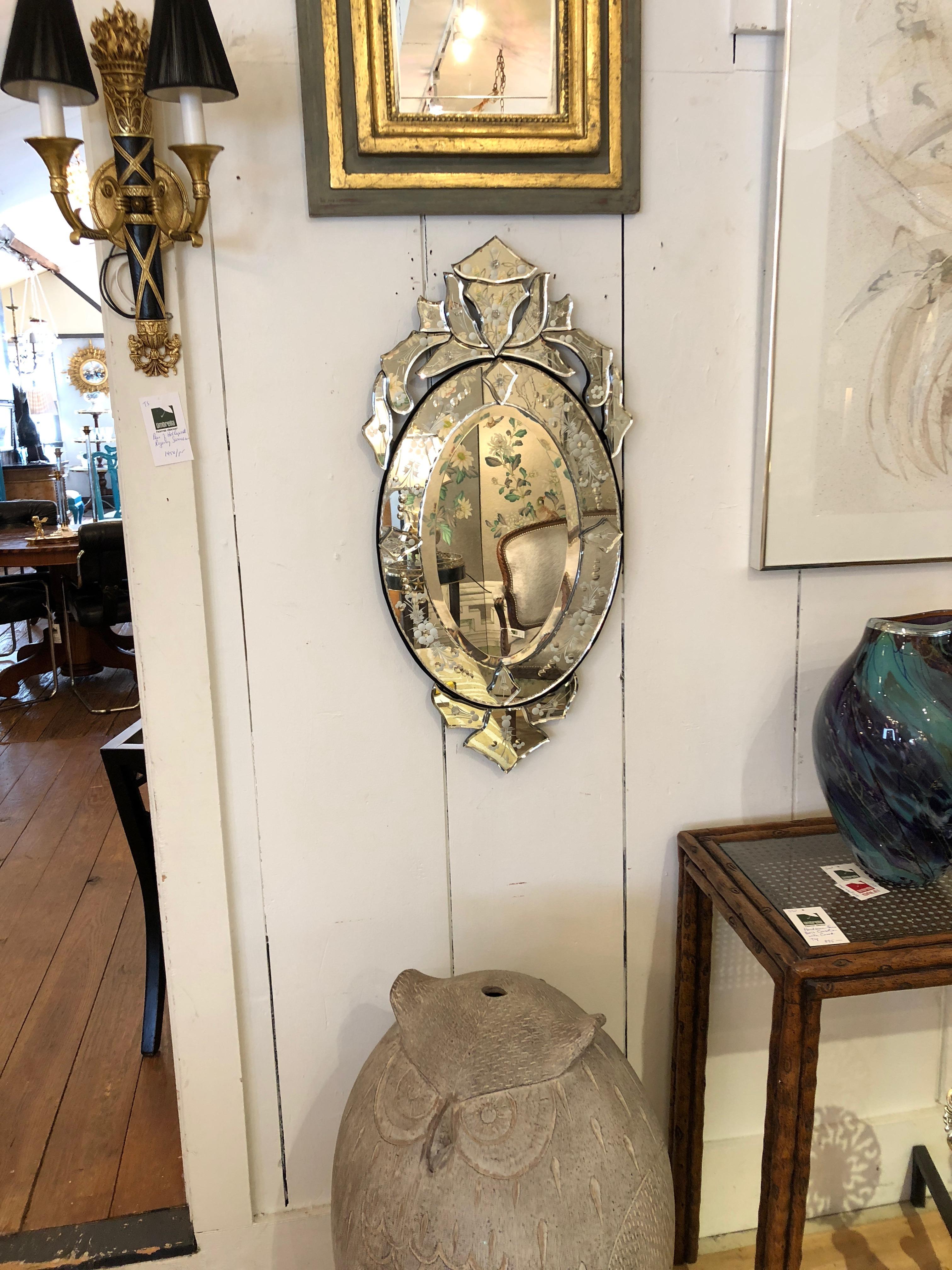 A lovely blast of glamour in a diminutive sized Venetian style mirror having pretty etched decoration and ornate top and bottom.