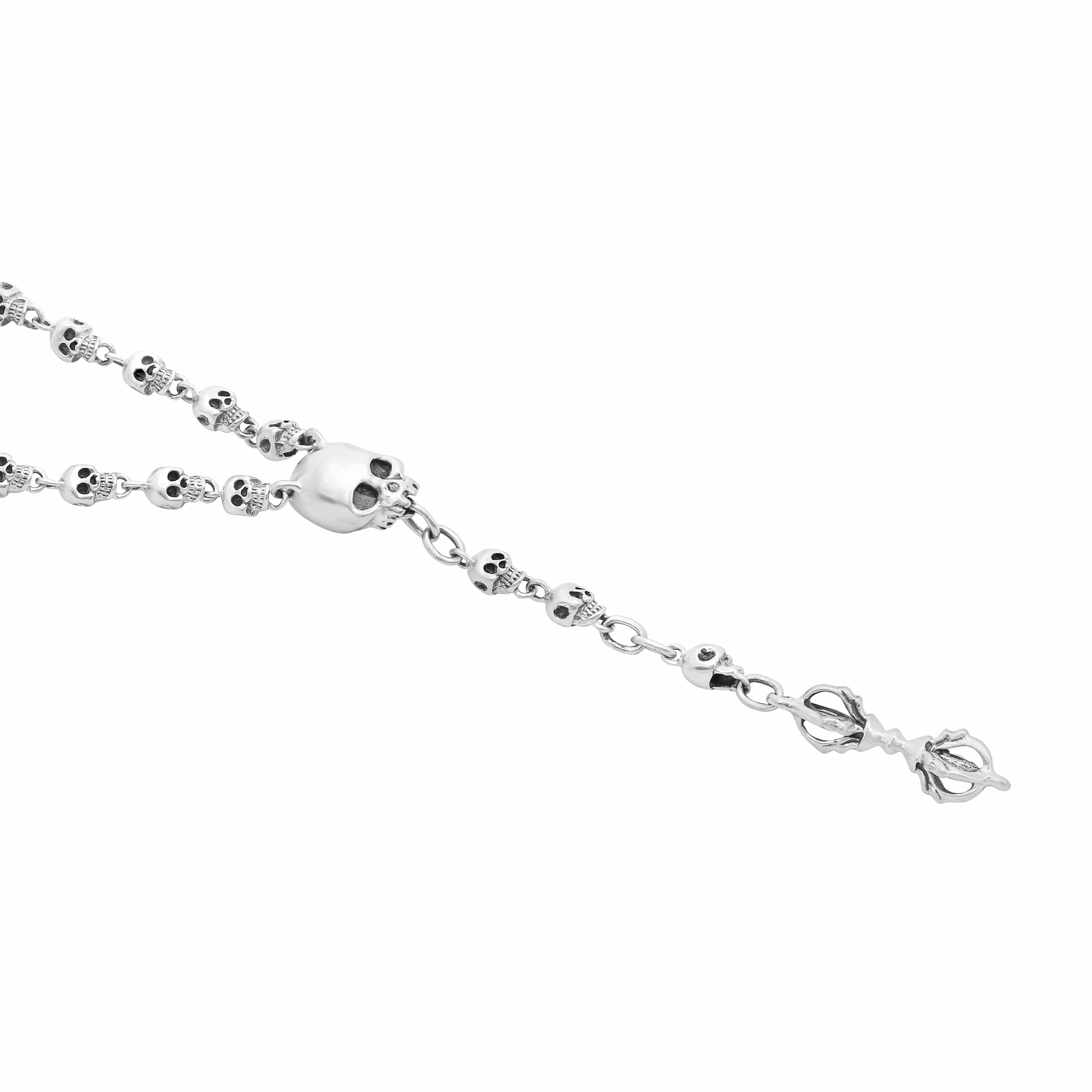 Jade Jagger’s silver small skull rosary is a finely crafted necklace featuring tiny, intricately detailed skull beads made from polished silver. The beads are linked together by delicate silver chains, forming a compact rosary with a balanced and
