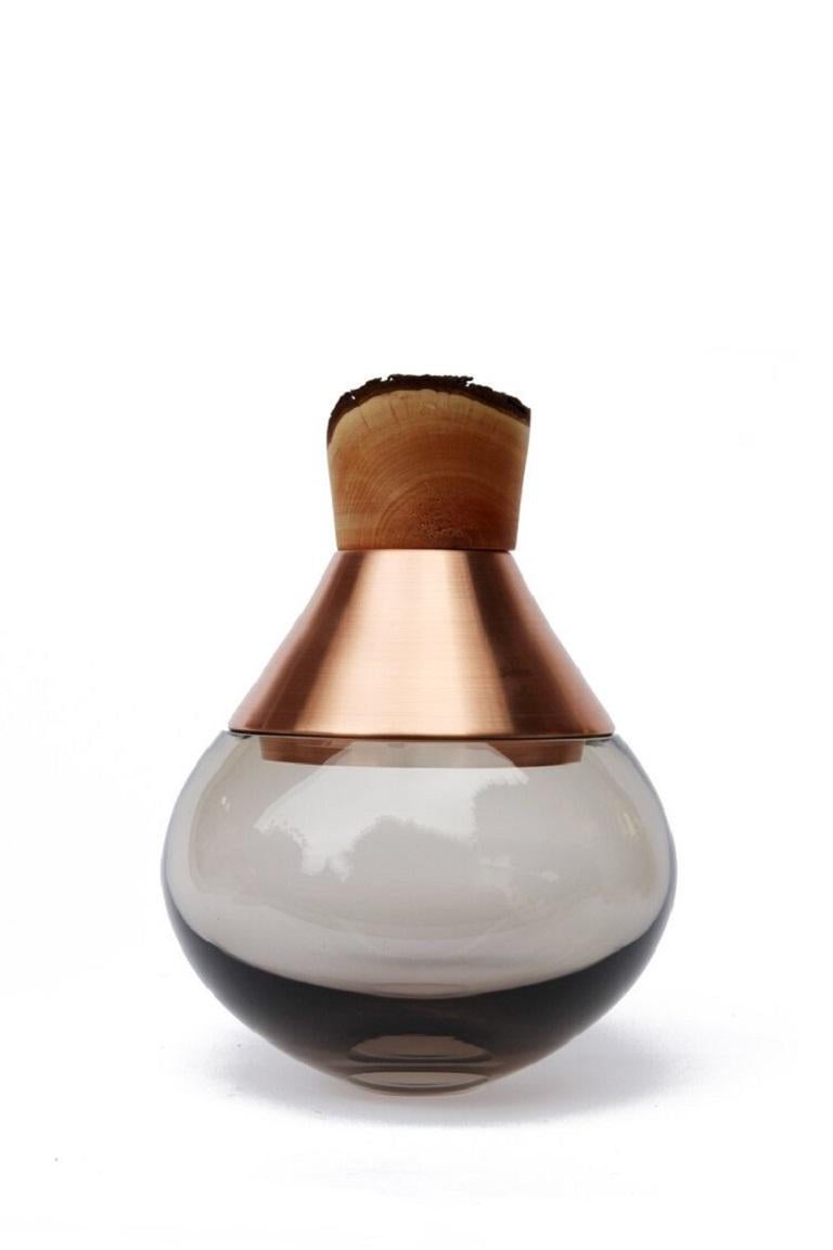Small smoke India vessel II, Pia Wüstenberg.
Dimensions: D 18 x H 25.
Materials: glass, wood, metal.
Available in other metals: brass, copper, copper patina.

Handmade in Europe, by individual craftsmen: handblown glass (Czech Republic), hand