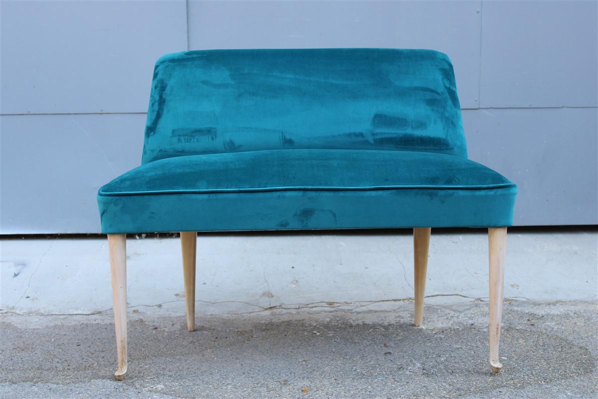 A small sofa with a pleasant shape, design and elegance, restored with a good petrol green velvet.