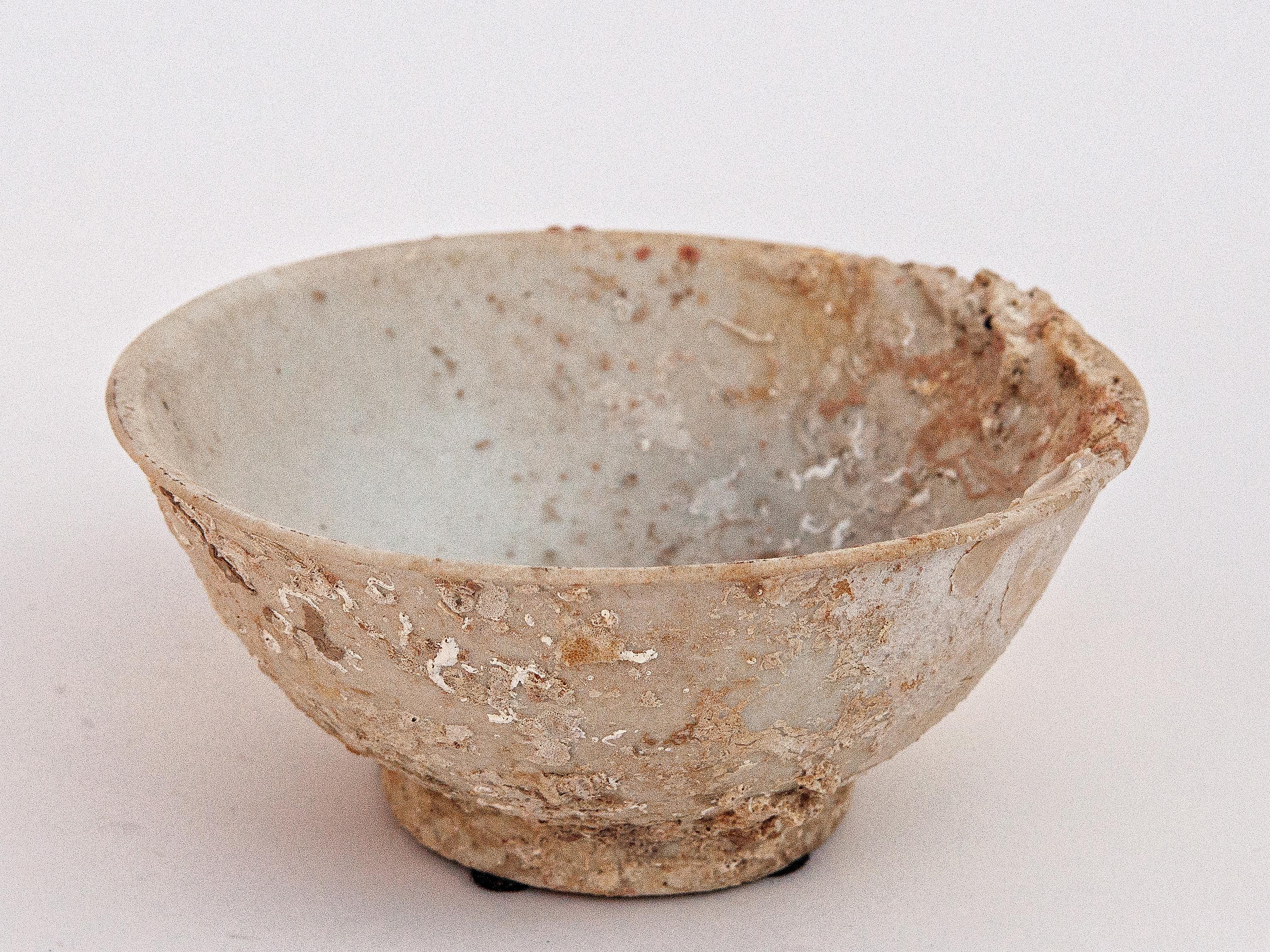 Small Song dynasty Celadon bowl with encrustations, 11th or 12th century, China.
This small ceramic bowl was salvaged from a shipwreck in the waters off the coasts of Sumatra and Malaysia. The accumulation of barnacles over many long years in the