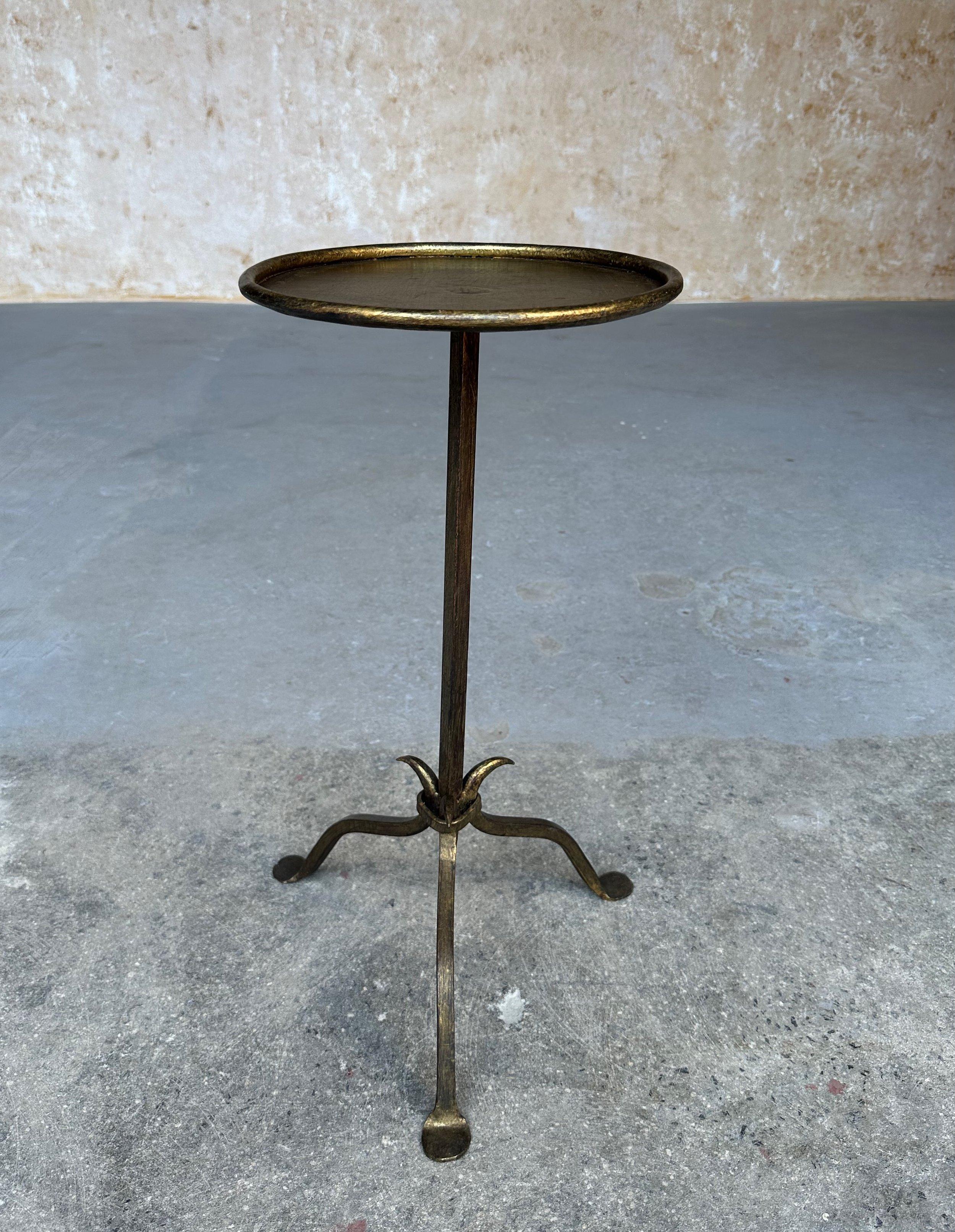 Recently crafted by skilled artisans using conventional iron-working techniques, this small iron and metal end table from Spain features a distinctive design with a central stem that tapers to a fine point, attached to a tripod base that comprises