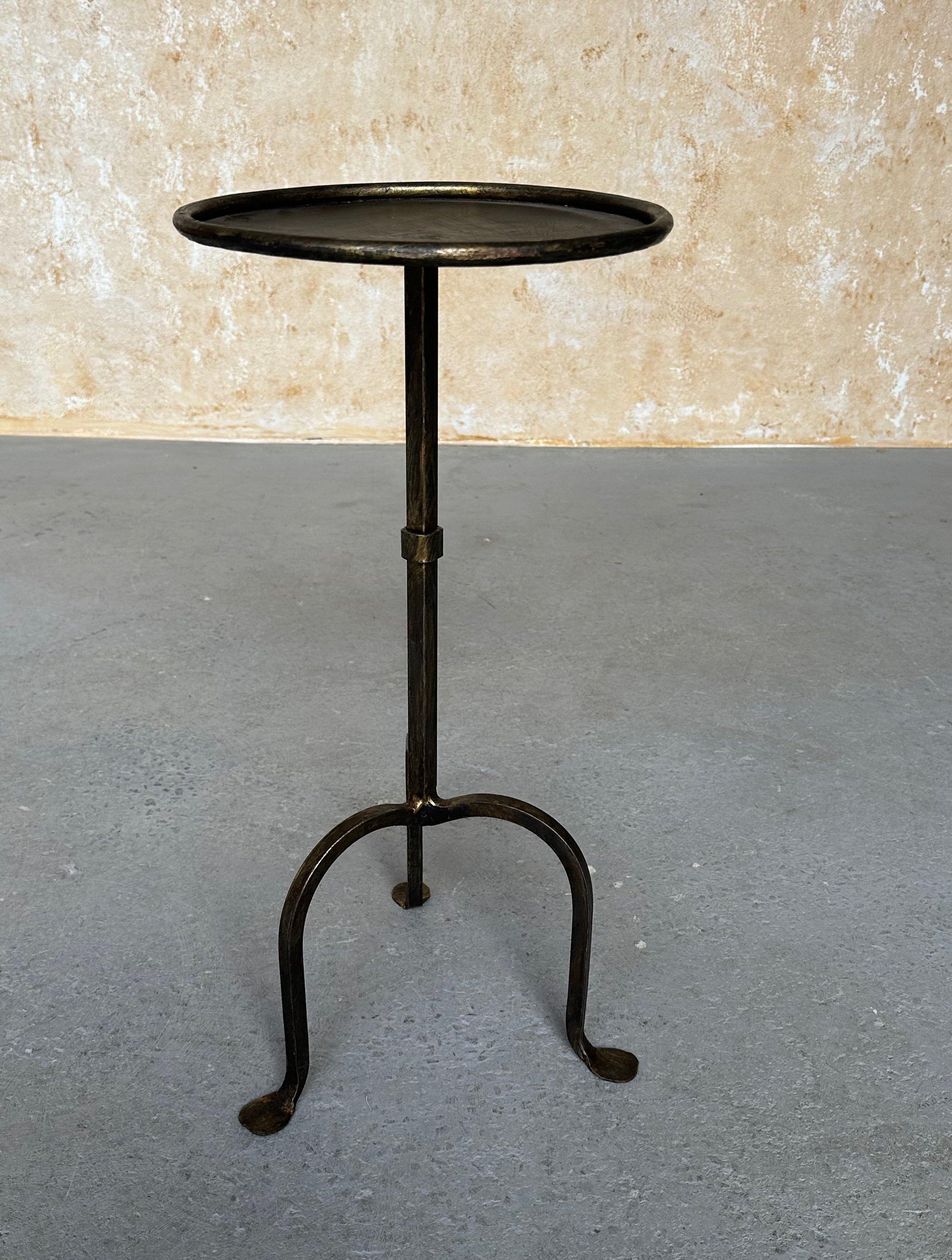 This small handcrafted Spanish iron end table was recently created by accomplished European artisans using traditional iron-working methods. Based on a vintage 1950s design, it features a square stem with a central ring accent and a gracefully