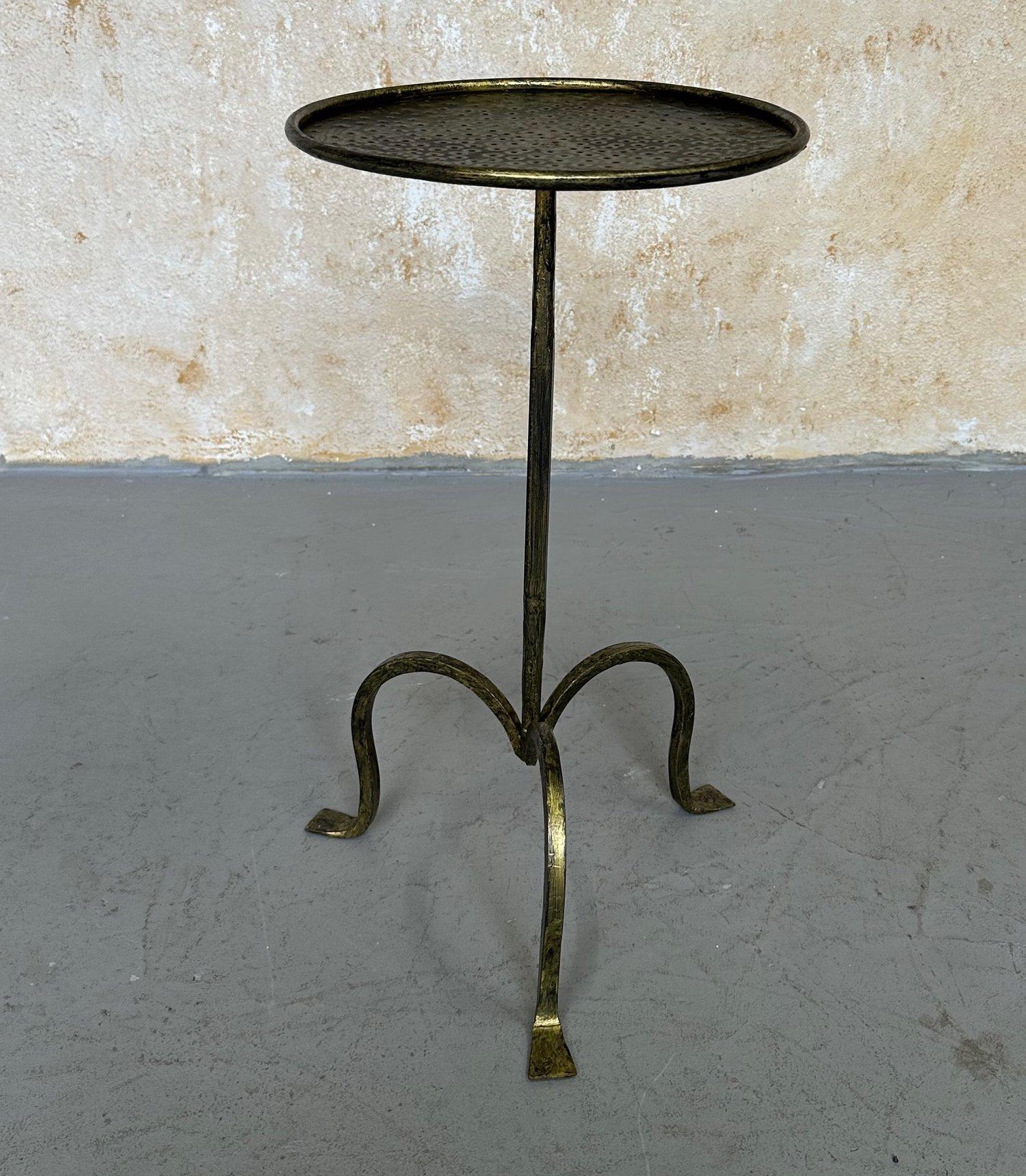 This exquisite Spanish drinks table has been meticulously hand-crafted by skilled European artisans, employing traditional ironworking techniques that have been passed down through generations. The design features a beautifully tapered central stem,