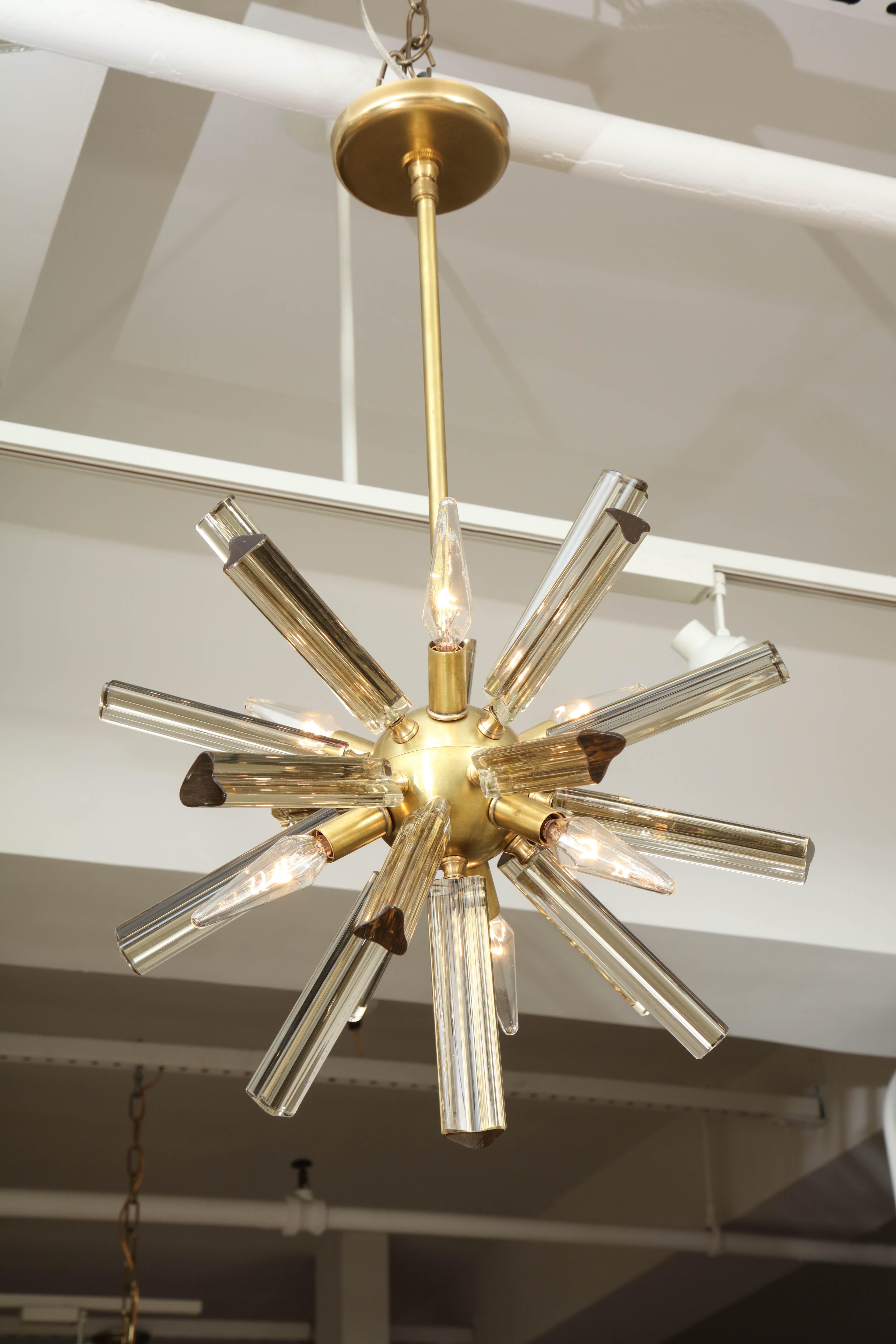 A glamorous little Italian sputnik chandelier with clear and amber triedri crystals surrounding a brass globe. Perfect for adding a bit of drama to a small space.