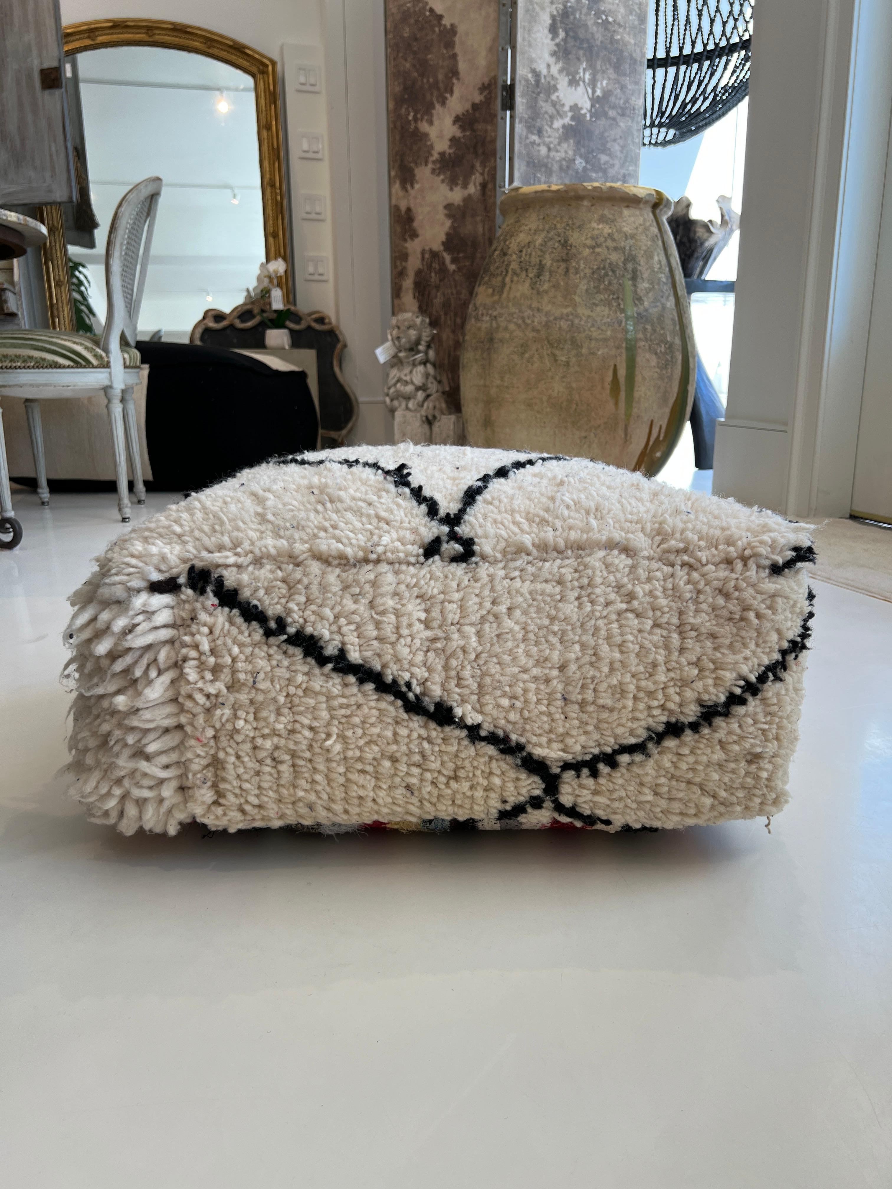 Large ottoman or pouf in a rustic woven wool.