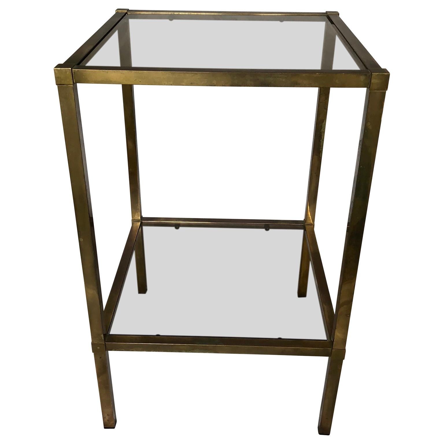 Square two-tier Italian gilded brass glass-top Mid-Century Modern side-table with original tinted glass panels.


      
