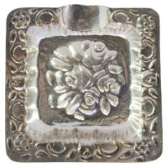 Small square-shaped silver ashtray with flower reliefs