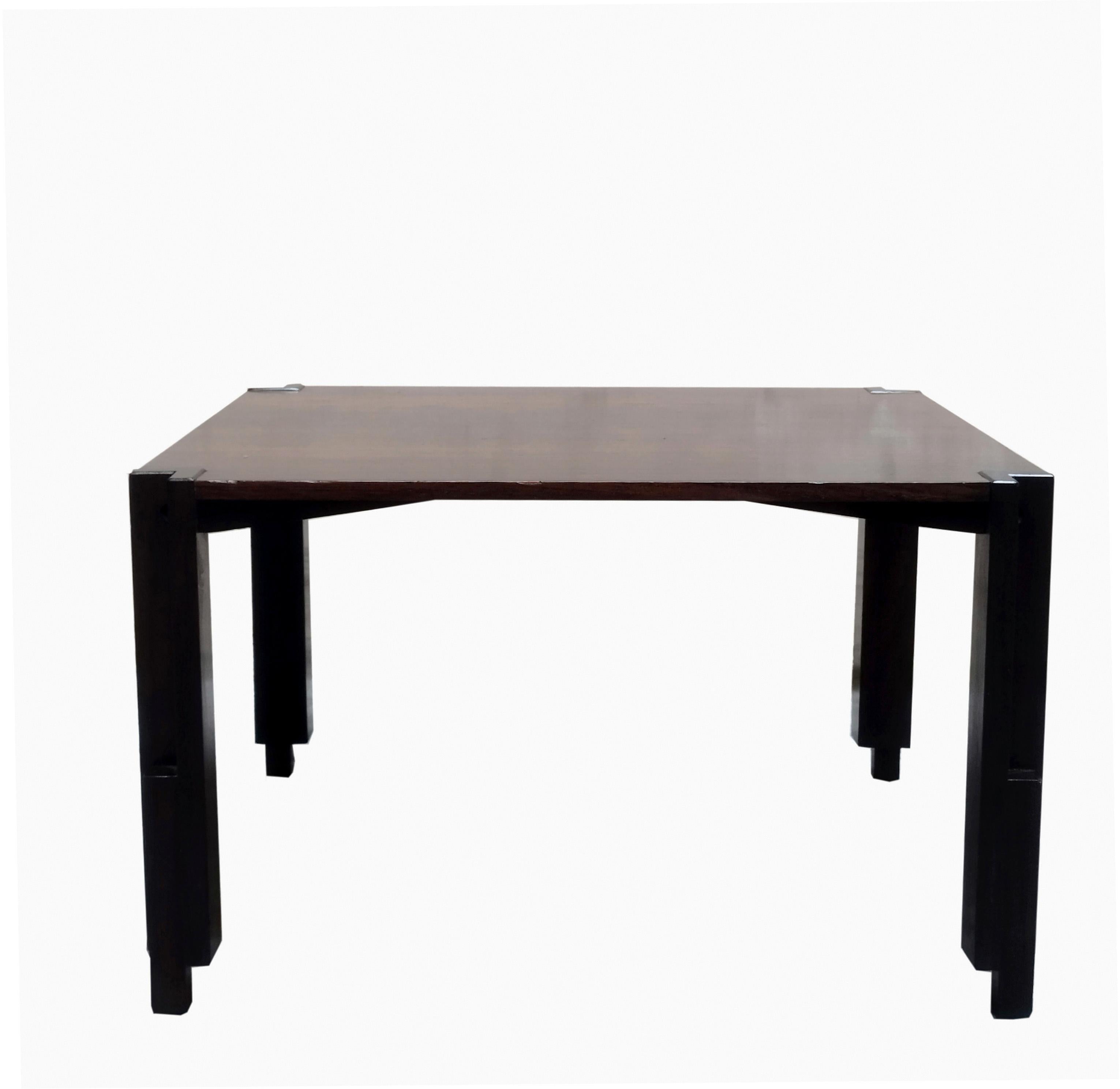 Beautiful wooden coffee table, understated and clean. This coffee table is very elegant in its simplicity. It includes 4 vertical feet and a wooden frame connected with two remarkable bolts. In very good overall condition, with some slight traces of