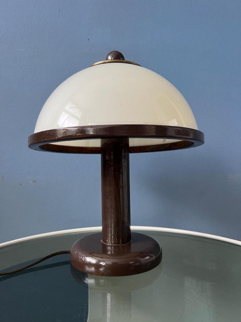 Small mushroom table lamp by Steinhauer made from wood and acrylic glass. The white acrylic glass shade produces a nice and warm light. The lamp requires one E27/26 (standard) lightbulb and currently has an EU-plug (works outside EU with