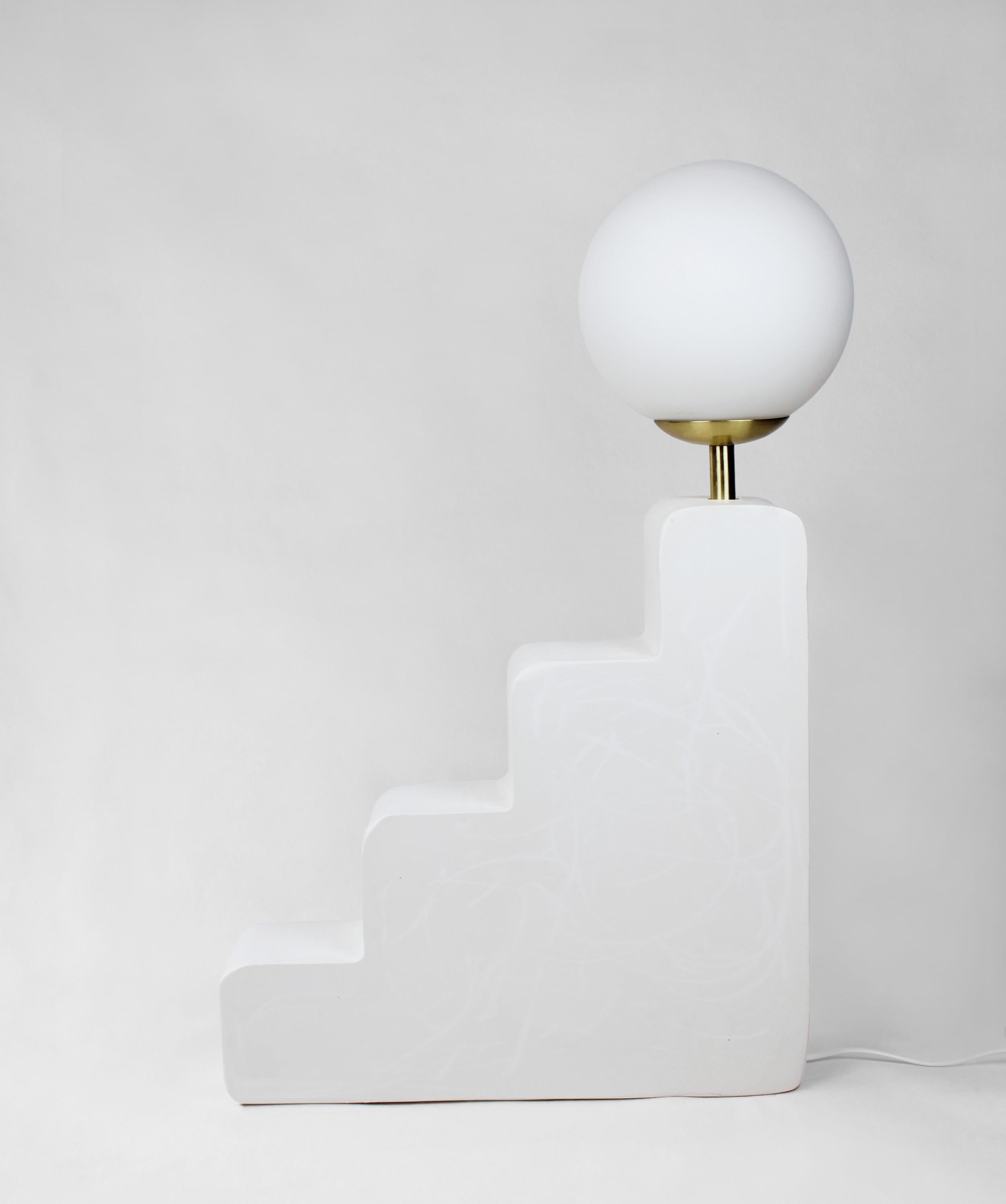 Small step lamp by AOAO
Dimensions: W 44 x D 11 x H 68 cm
Materials: White Plaster
Color options available upon request.

The idea was born after deciding to reconnect with my family and my grandfather – a sculptor artist. Learning to sculpt