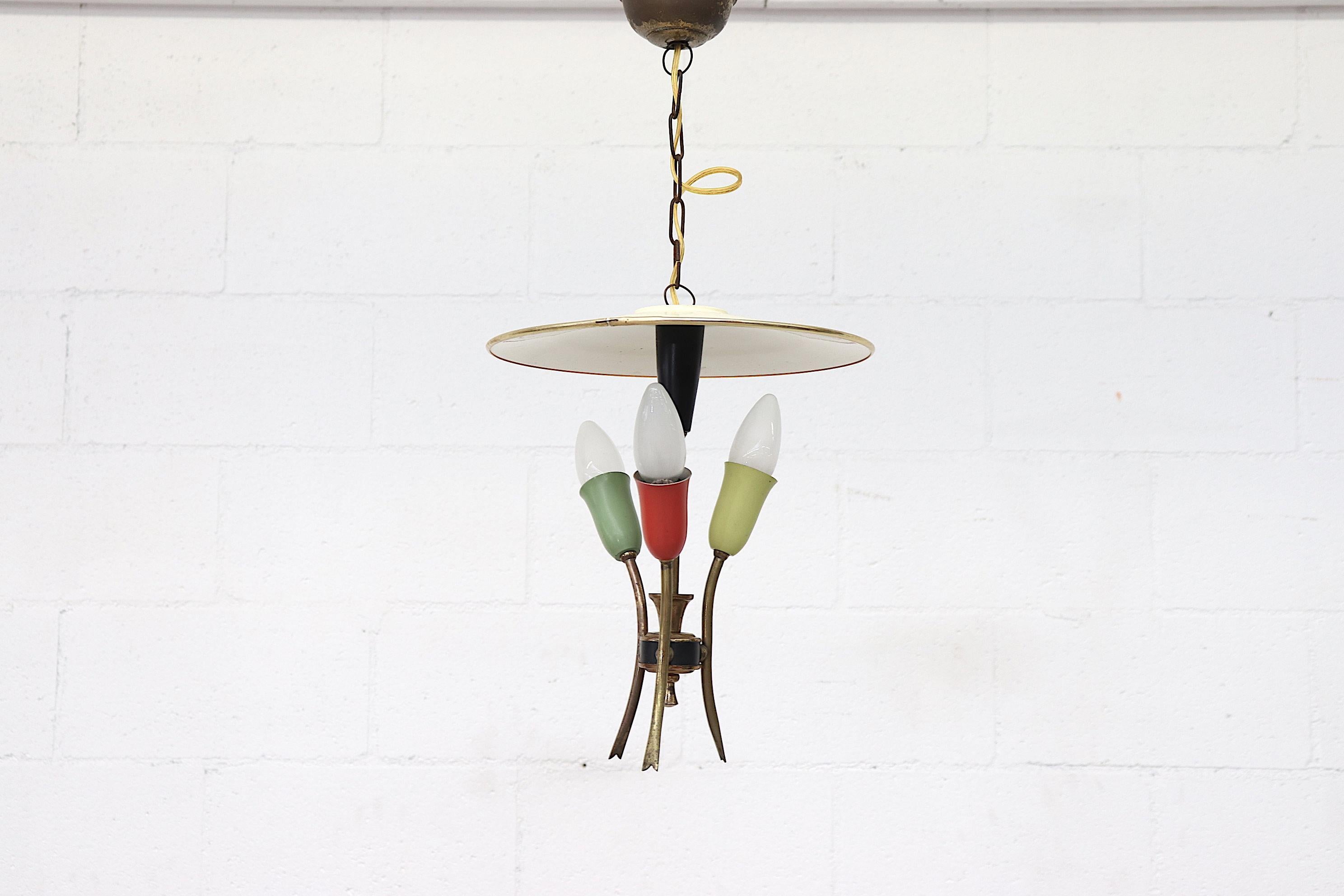 Beautiful Brass Stilnovo style three bulb chandelier with spun enameled metal hat. Classy and elegant design with energetic red, green and lime green sockets to accent. In original condition with minor scratches and some wear. European candelabra