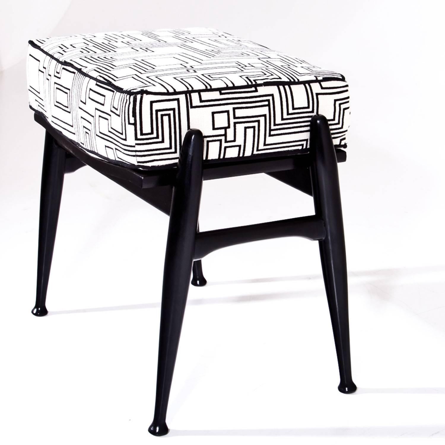 Small stool on ebonized legs with a rectangular cushioned seat. The seat was reupholstered with a high quality fabric by designer Eley Kishimoto.