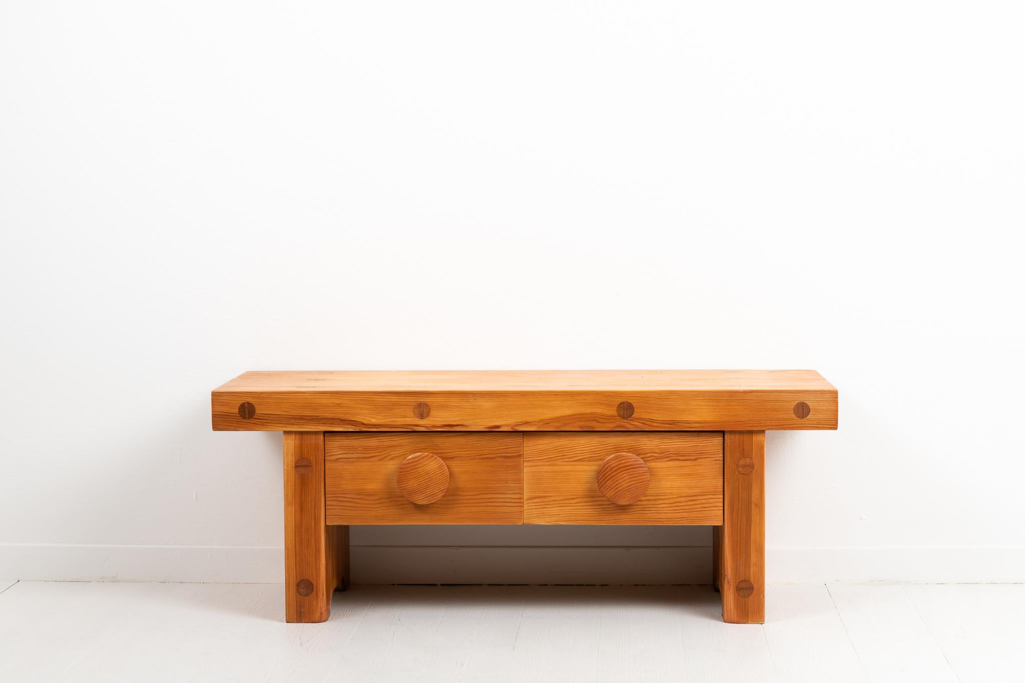 Small pine bench or side table from Sweden. Designed by Roland Wilhelmsson and made by Karl Andersson & Söner, Huskvarna during the 1970s. The bench has a simple design and sturdy construction and the colourful wood means the bench doesn't need any