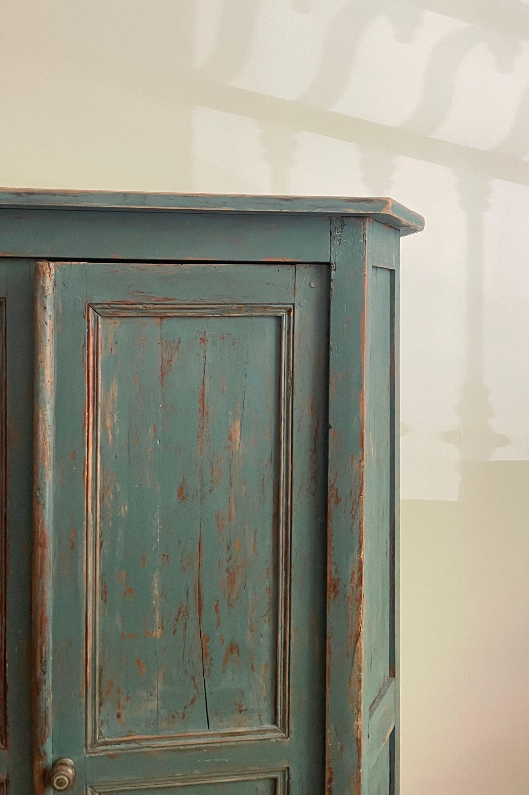 Small Swedish cupboard with green patinated paint.

