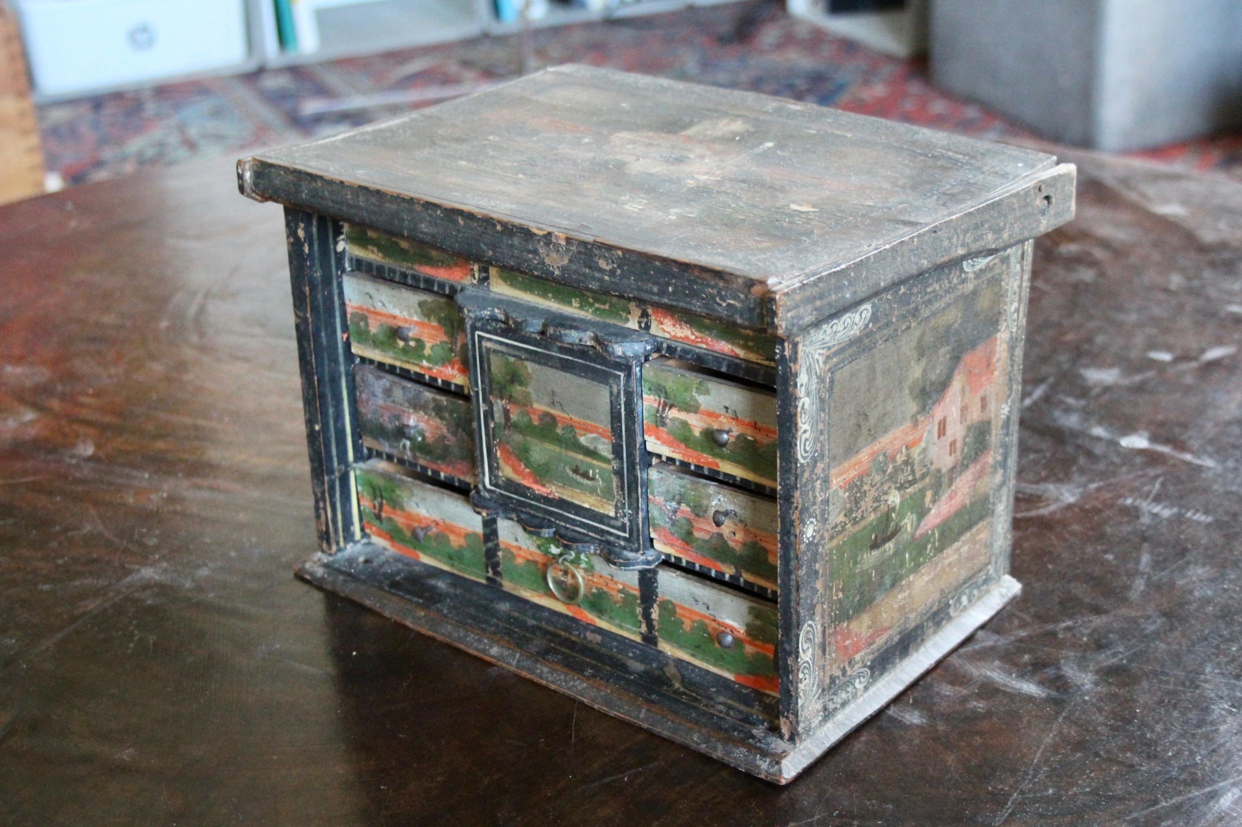 small Swiss Alps cabinet painted on all sides there is a hiding place inside, unfortunately the door on the front is missing