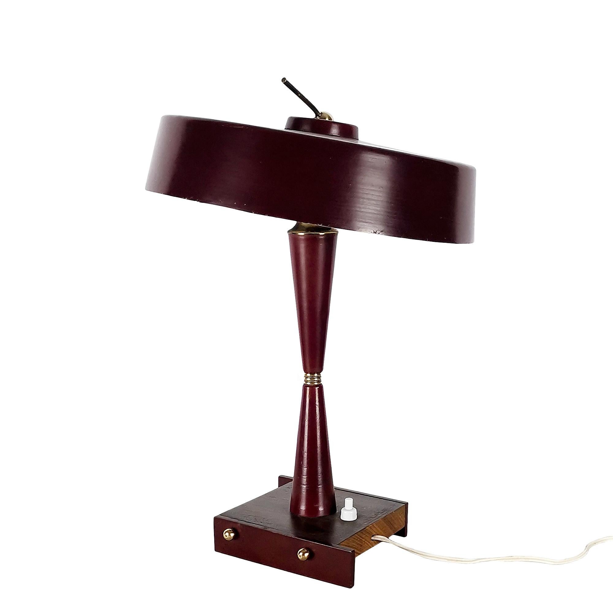 Small table lamp: base in solid rosewood and burgundy lacquered steel, foot and lampshade in lacquered aluminium, adjustable lampshade. Details in polished brass. Two bulbs.
Manufactured by Stilux Milano.

Italy, circa 1950.